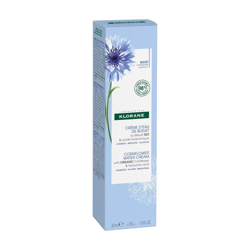 Boîte bleu clair avec fleur bleue et texte. Contient Crème d'Eau de Bleuet. 30ml. 98% d'ingrédients naturels.