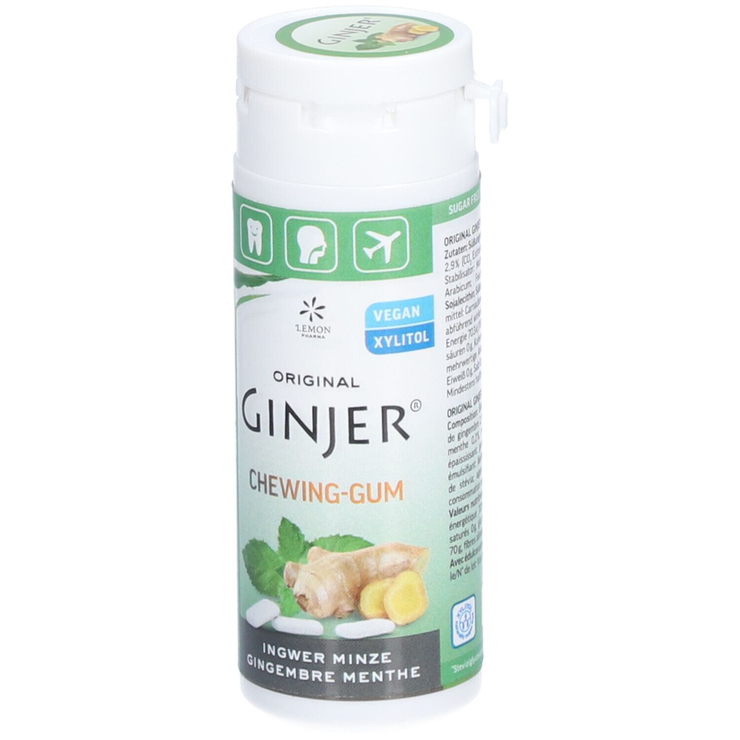Boîte blanche avec étiquette verte. Inscription : GINJER CHEWING-GUM. Illustration de gingembre et menthe. Vegan, Xylitol.