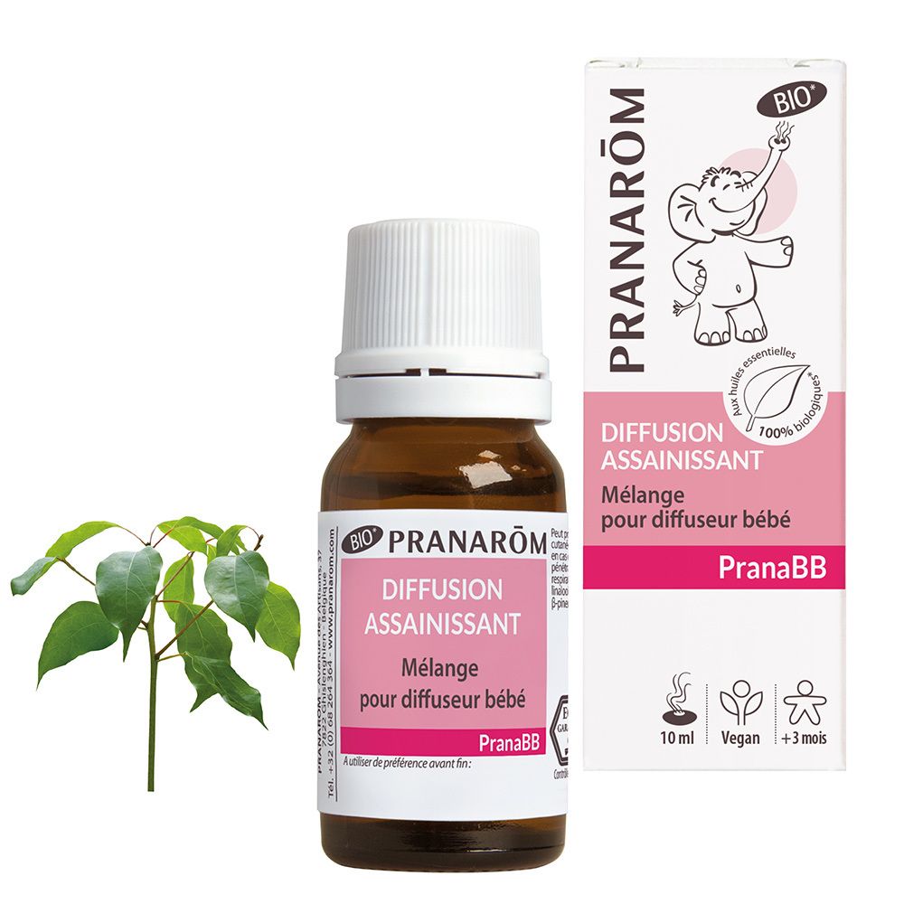Flacon en verre brun avec bouchon blanc et étiquette rose. Boîte avec informations produit et branche verte à côté.
