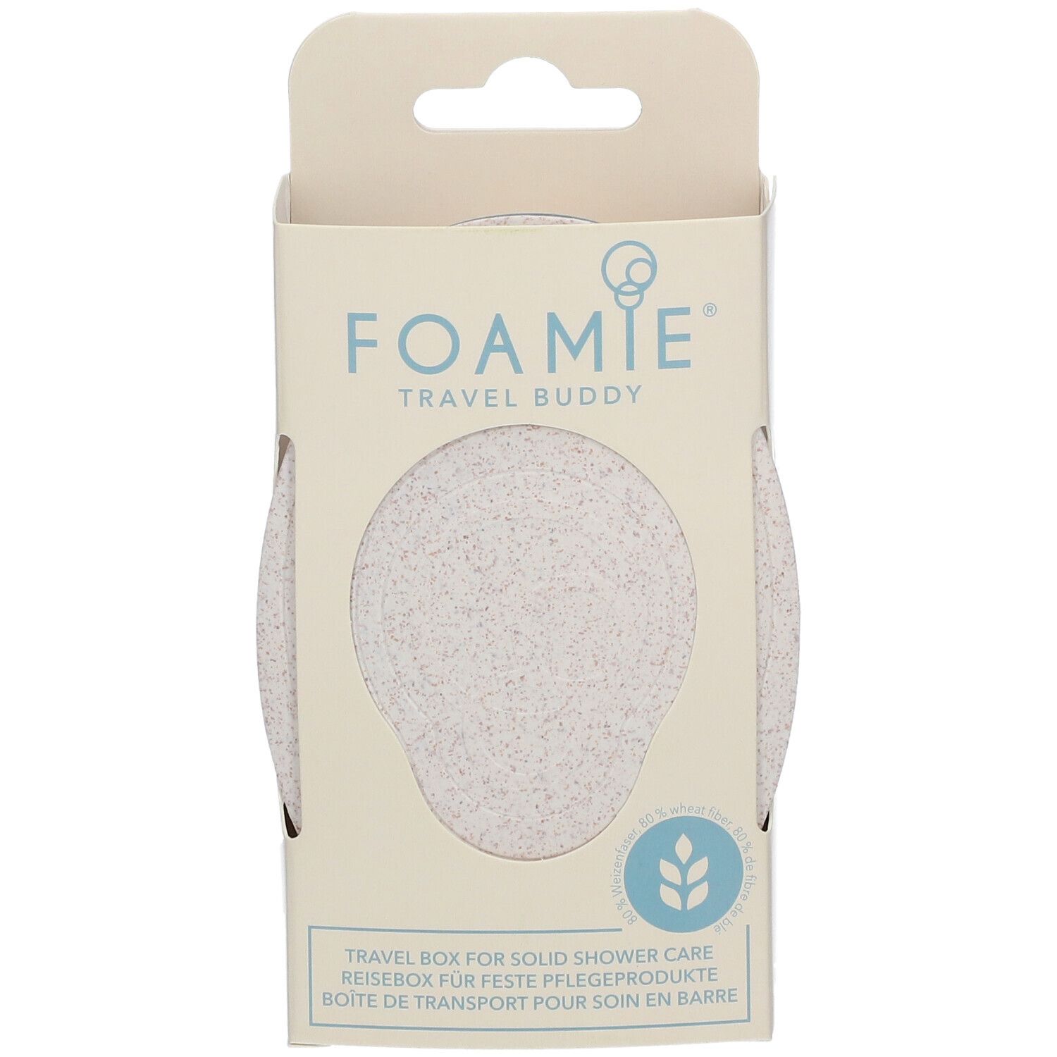 Frontansicht der Verpackung. FOAMIE Travel Buddy in Box. Sichtfenster zeigt helles Produkt. Text: Reisebox für feste Pflegeprodukte.