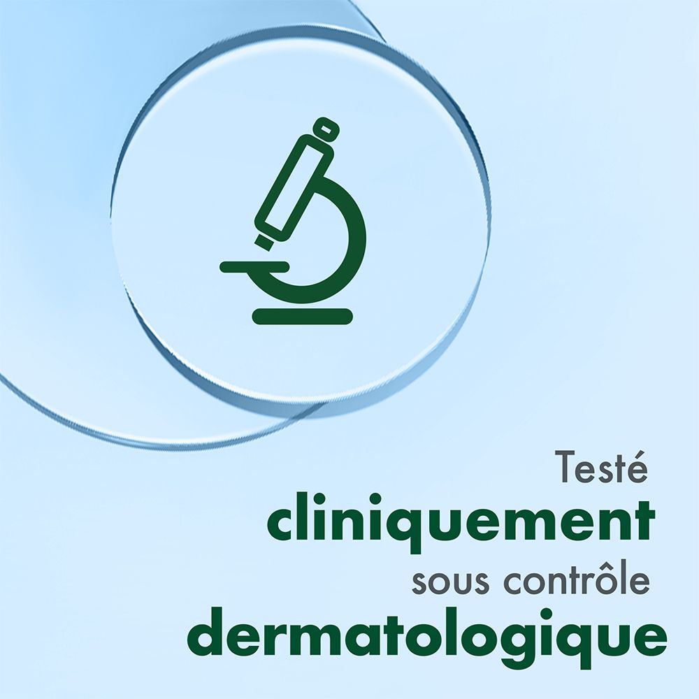 Symbole de microscope. Texte: Testé cliniquement sous contrôle dermatologique. Fond bleu.