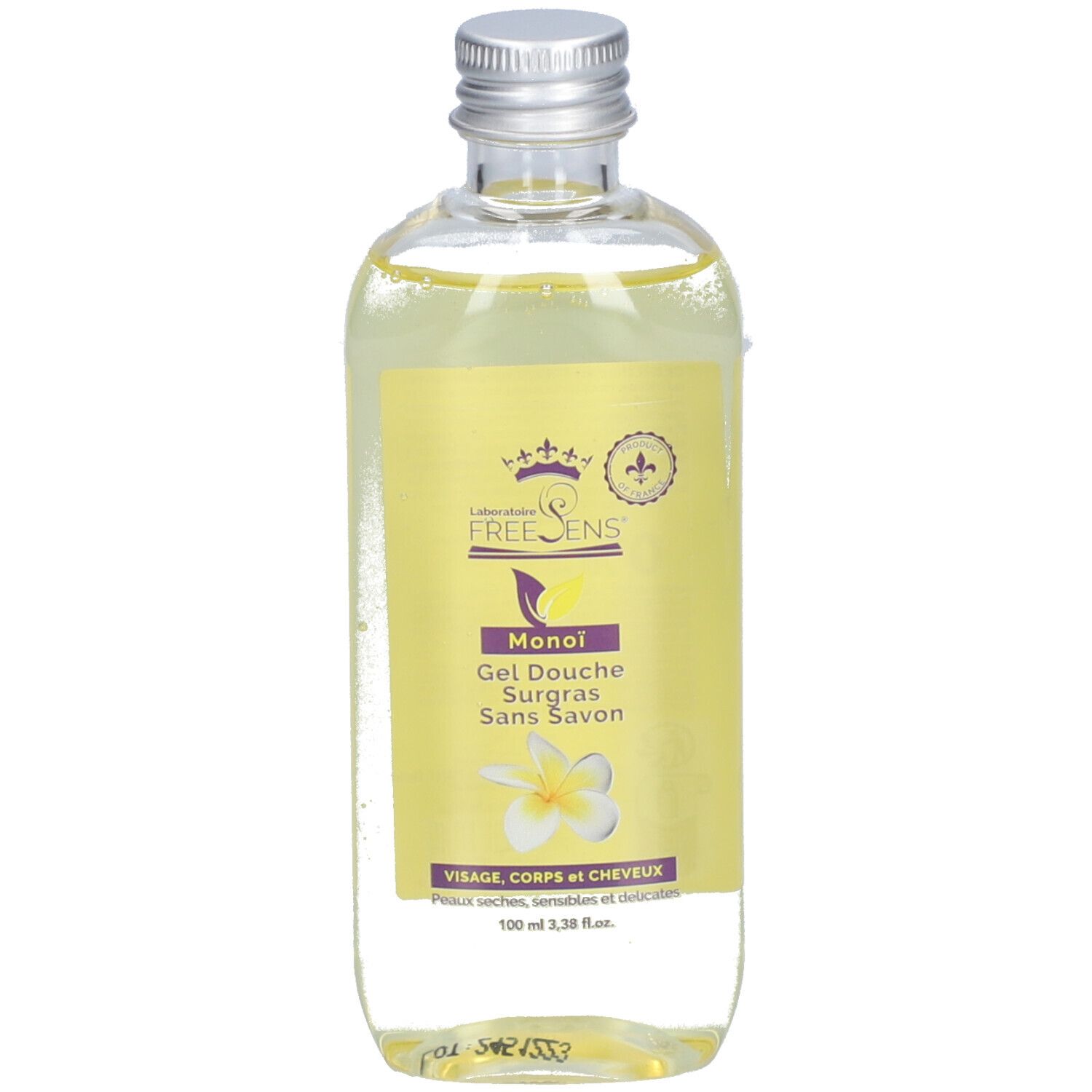 Transparante fles met geel etiket. Tekst: Freesens, Gel Douche Surgras Sans Savon au Monoï. Bloem afgebeeld.