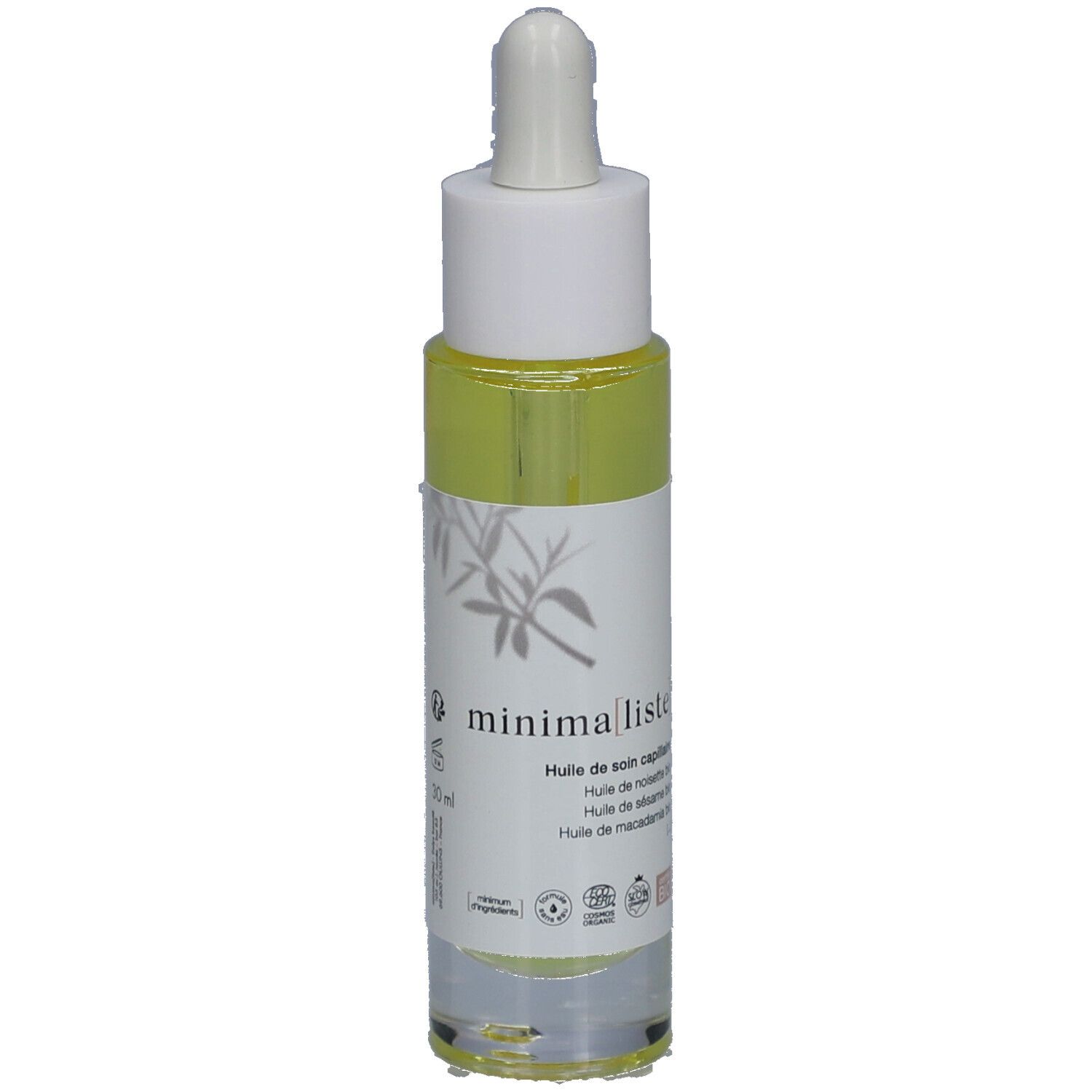 Flacon d'huile capillaire avec pipette. Étiquette avec nom du produit et certifications. Liquide jaune visible.