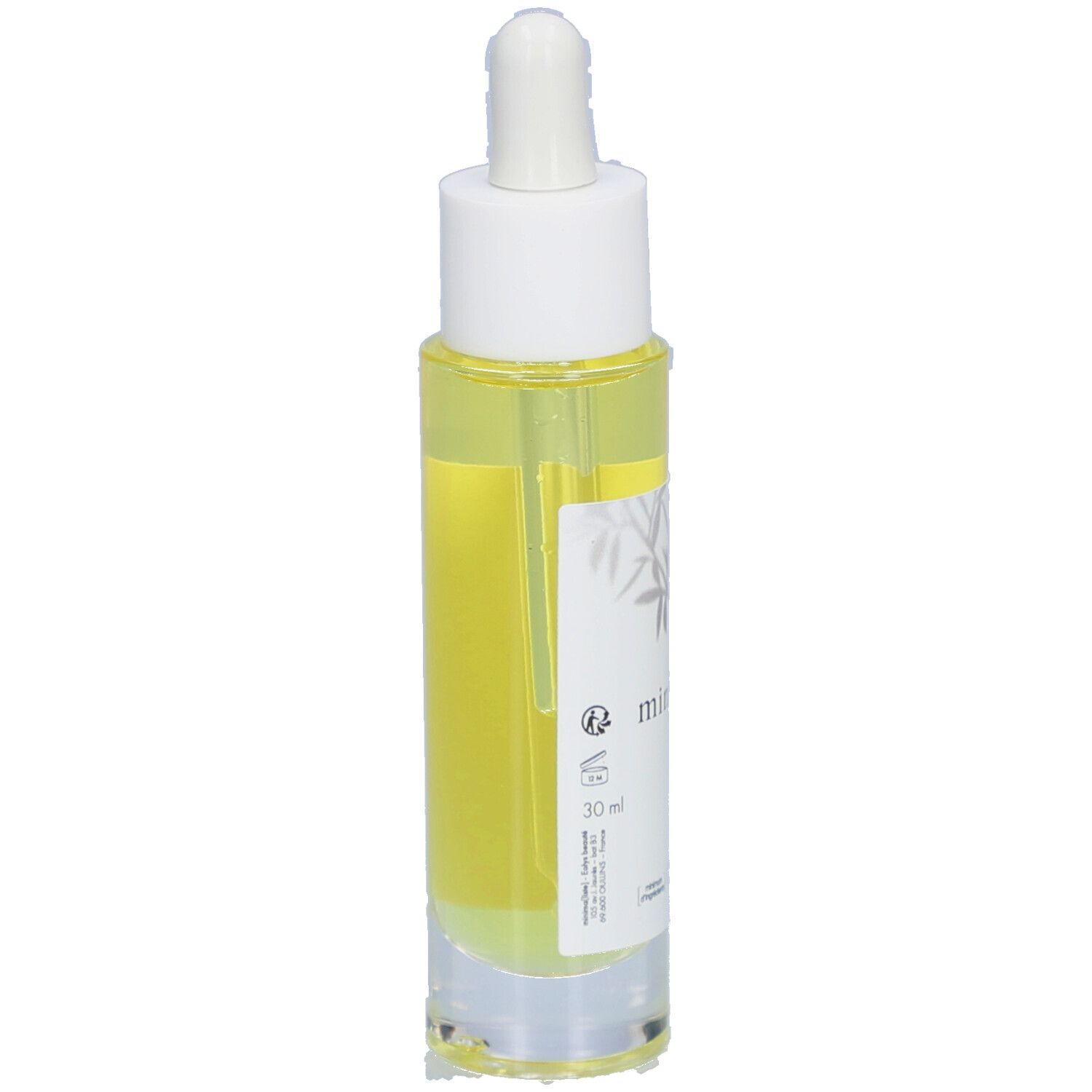 Flacon d'huile capillaire avec pipette. Étiquette avec nom du produit et certifications. Liquide jaune visible.