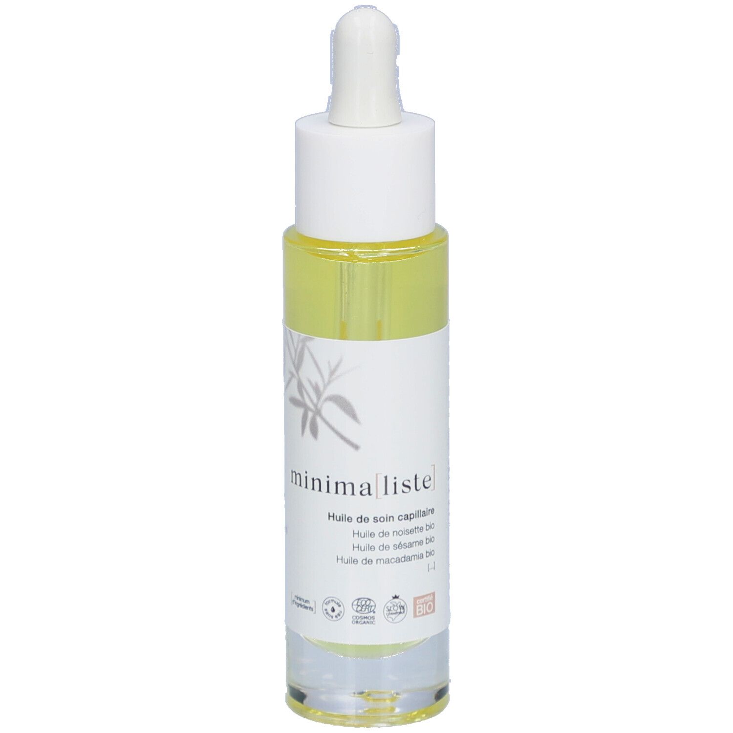 Flacon d'huile capillaire avec pipette. Étiquette avec nom du produit et certifications. Liquide jaune visible.