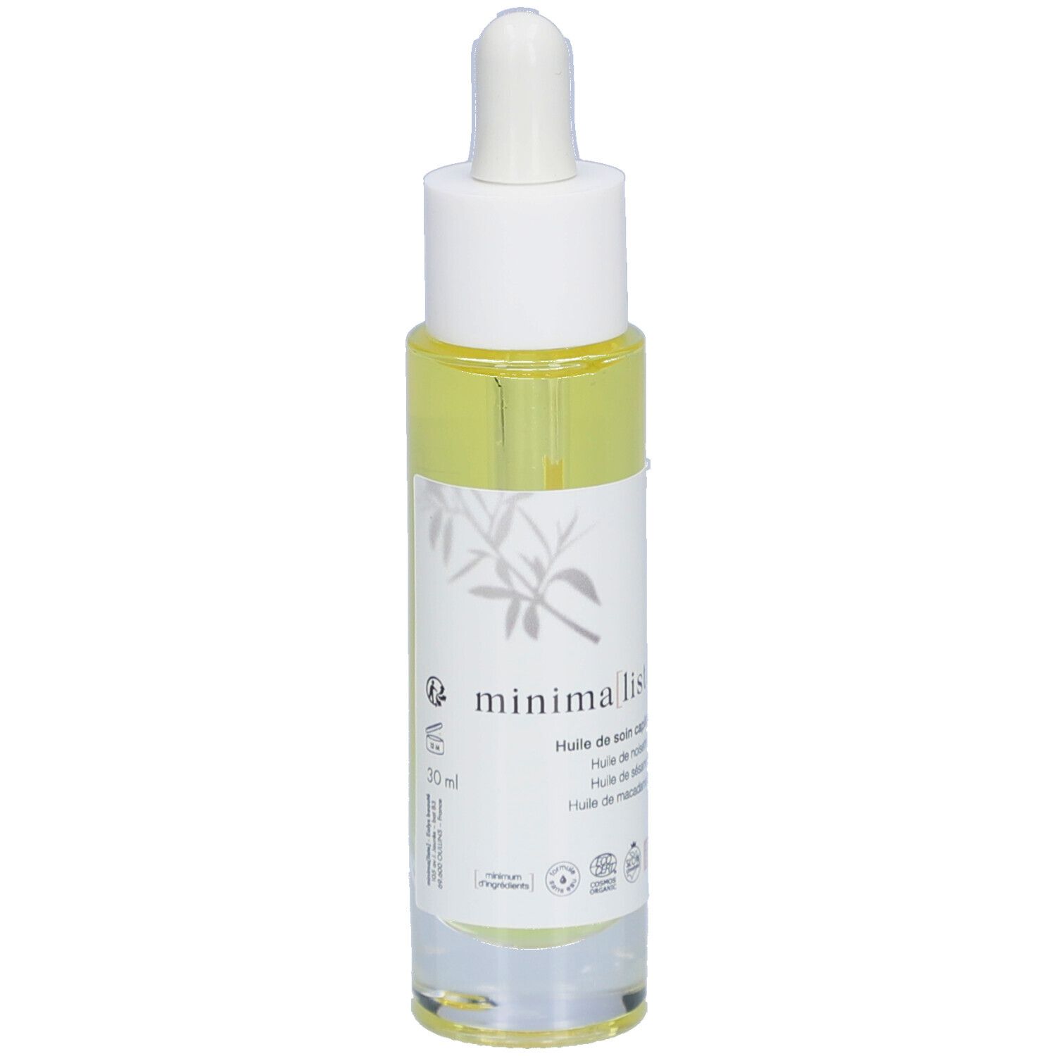 Flacon d'huile capillaire avec pipette. Étiquette avec nom du produit et certifications. Liquide jaune visible.