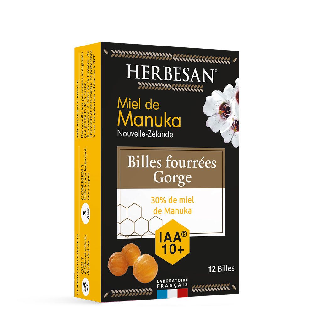 Boîte de HERBESAN® Miel de Manuka IAA 10+ avec 12 billes. Fond noir, accents jaunes, fleur blanche. Label IAA 10+.