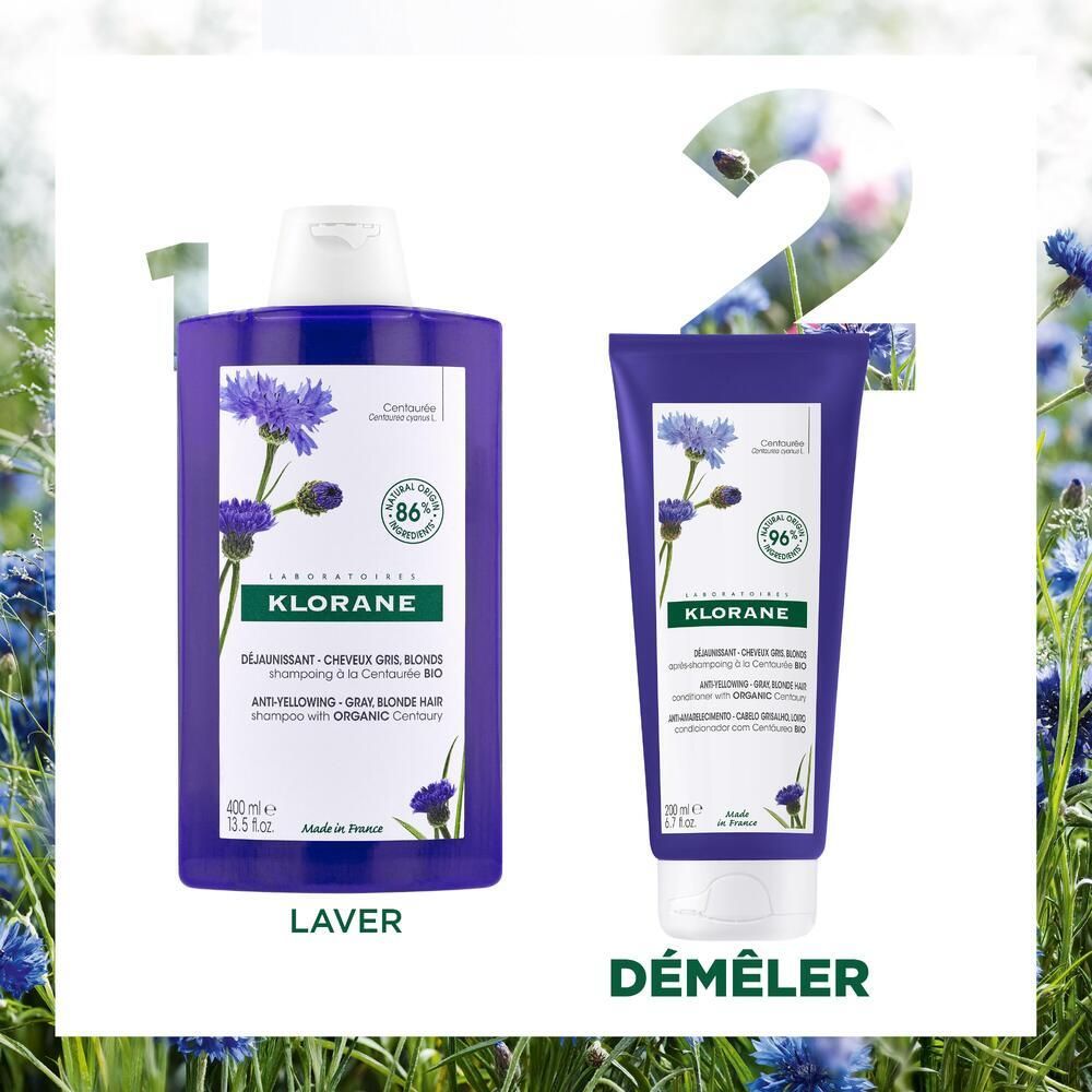 Twee producten naast elkaar: shampoo en conditioner. Beide in blauwe flessen. Opschrift: Klorane, korenbloem.