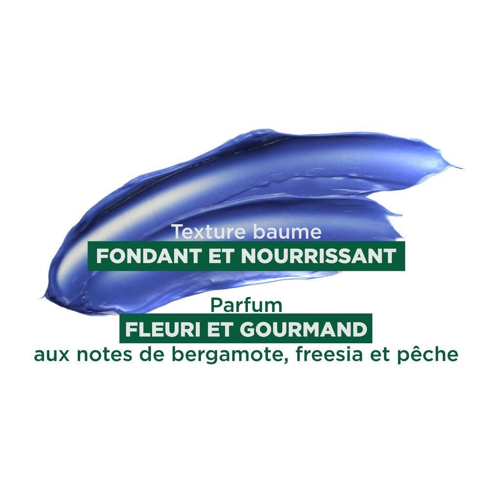 Blauwe crème textuur. Tekst: Fondant et nourrissant. Parfum: fleuri et gourmand. Noten van bergamot, fresia en perzik.