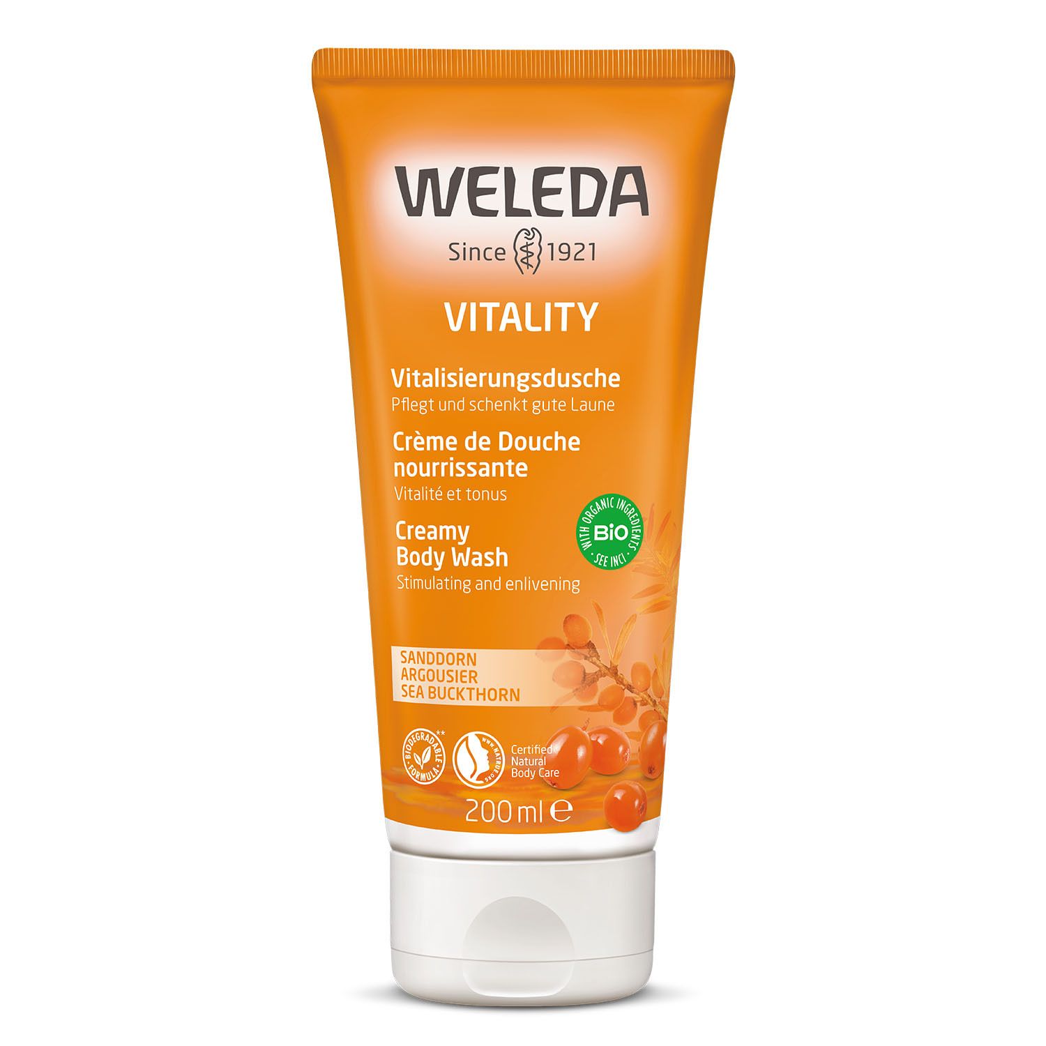 Tube orange avec texte. Marque: Weleda. Texte: Vitalisierungsdusche, Crème de Douche, Creamy Body Wash. Label Bio.