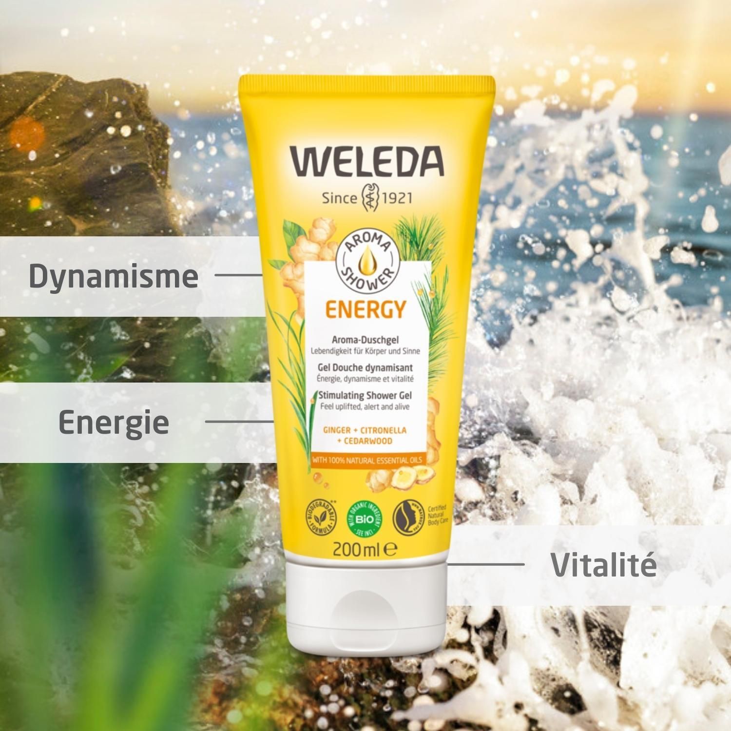 Tube jaune "WELEDA ENERGY Aroma-Duschgel" devant fond marin. Texte: Dynamisme, Énergie, Vitalité.