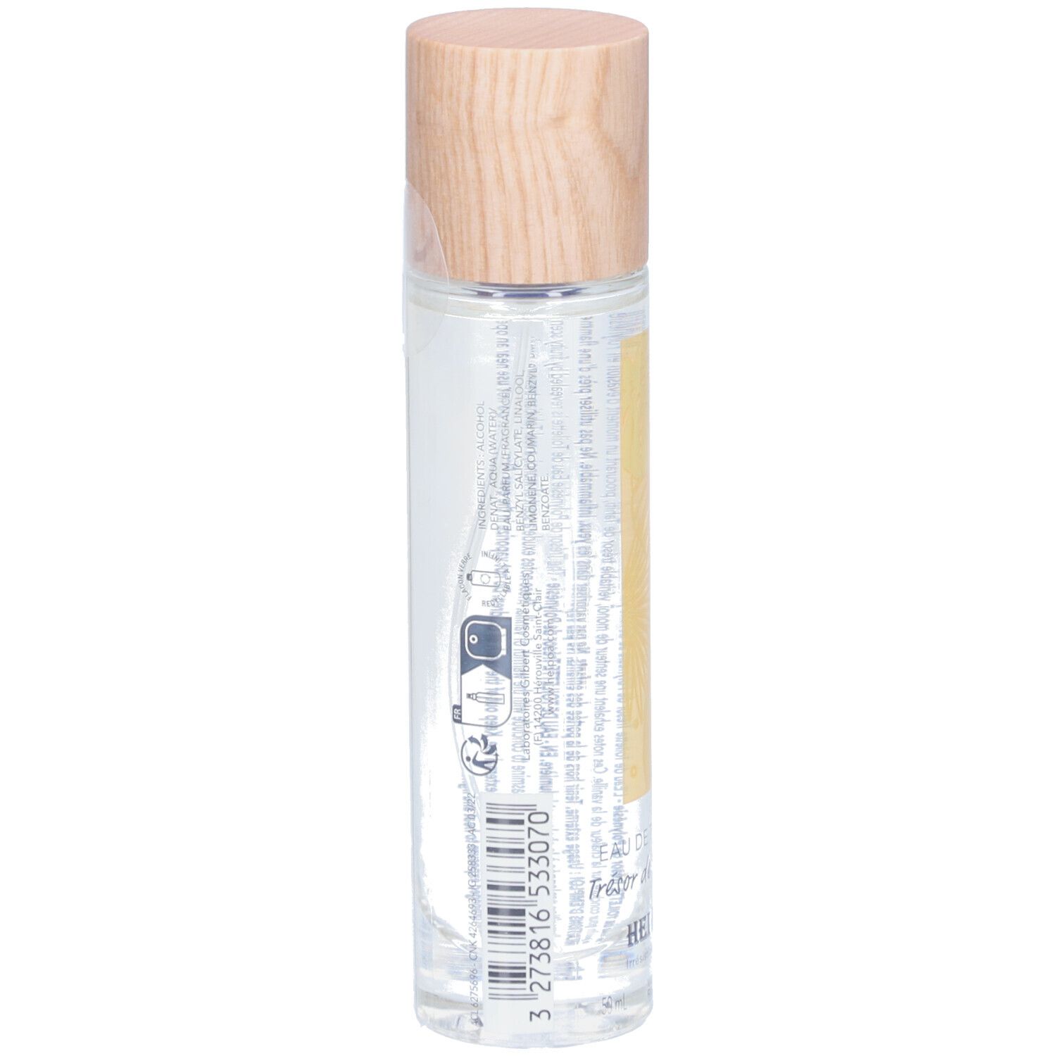 Flacon cylindrique en verre avec bouchon en bois. Dos avec texte et code-barres. Produit: HEI POA EAU DE TOILETTE Trésor de Polynésie.
