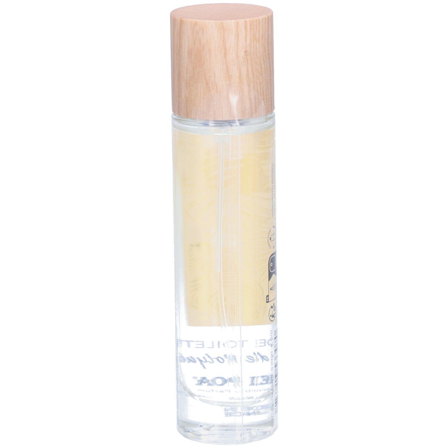 Flacon cylindrique en verre avec bouchon en bois. Étiquette avec motif de feuille jaune et texte: EAU DE TOILETTE Trésor de Polynésie. Marque: HEI POA.