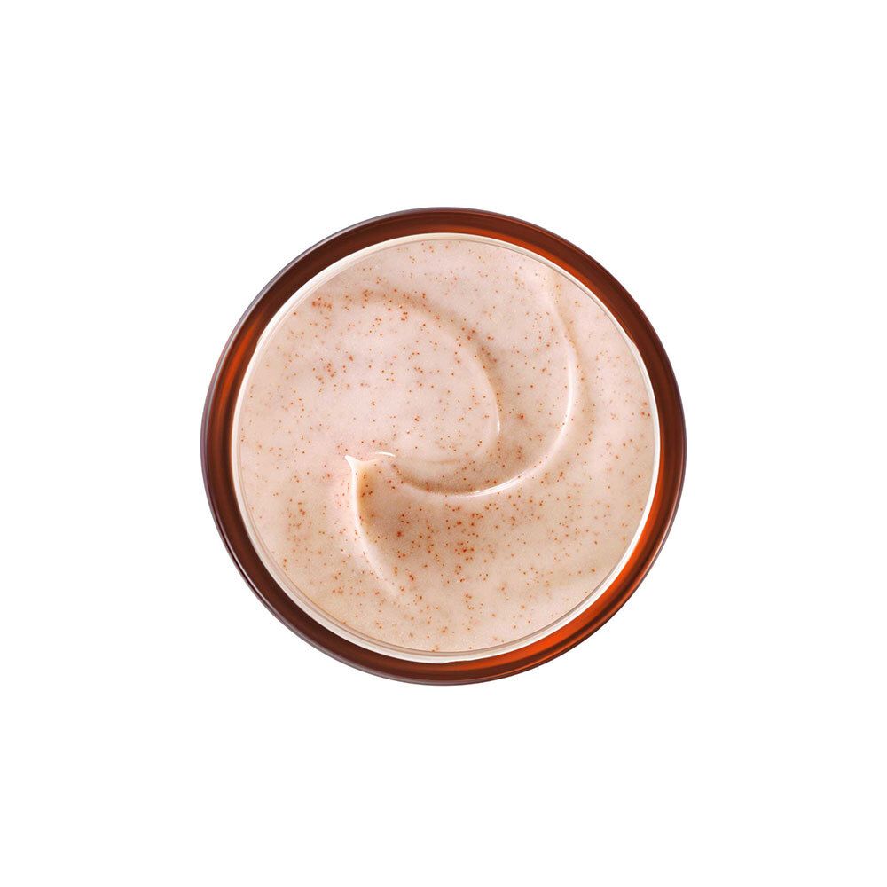 Draufsicht auf Creme. Cremefarbene Creme mit roten Partikeln in einem braunen Tiegel.