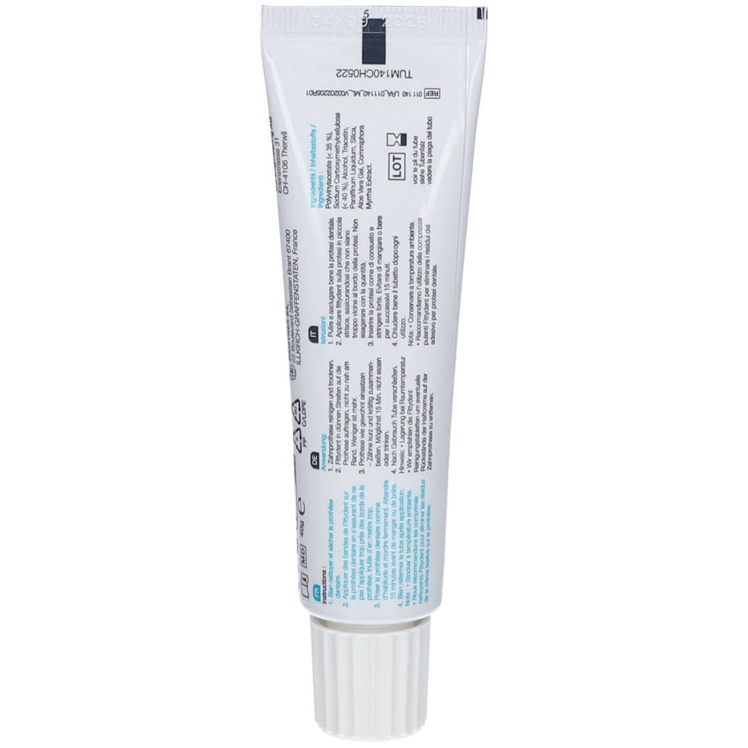 Dos d'un tube de crème fixative pour prothèse dentaire. Contient des informations et des instructions.
