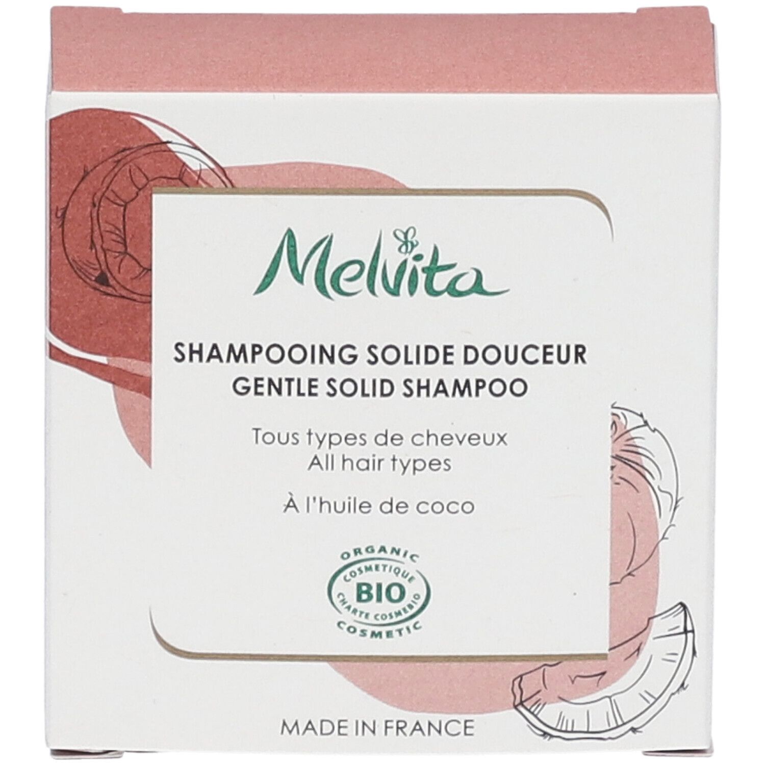 Vorderansicht der Shampoo-Verpackung. Text: "Melvita", "Shampooing solide douceur", "BIO COSMETIC". Kokosnuss-Illustration.