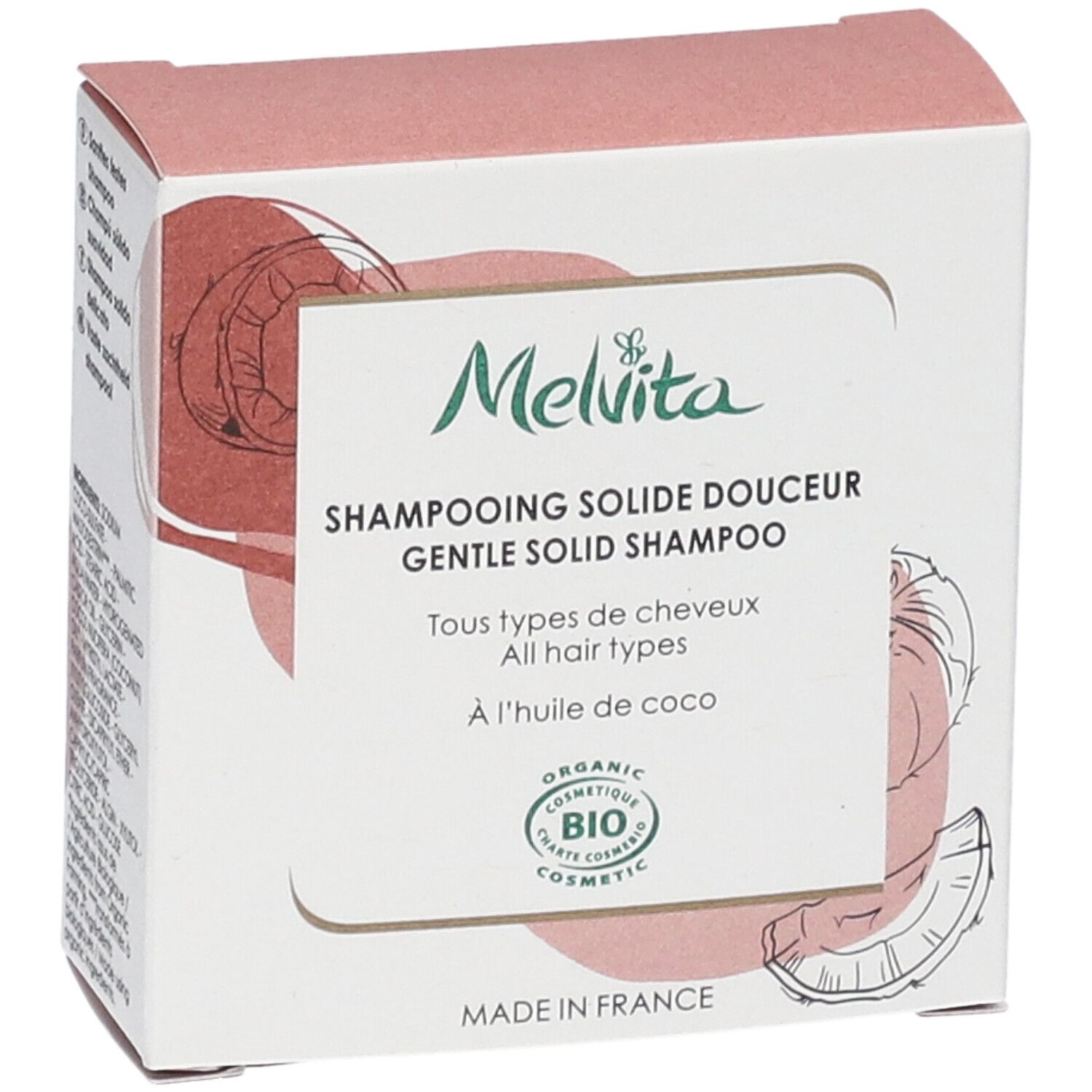 Seitenansicht der Shampoo-Verpackung. Text: "Melvita", "Shampooing solide douceur", "BIO COSMETIC". Kokosnuss-Illustration.