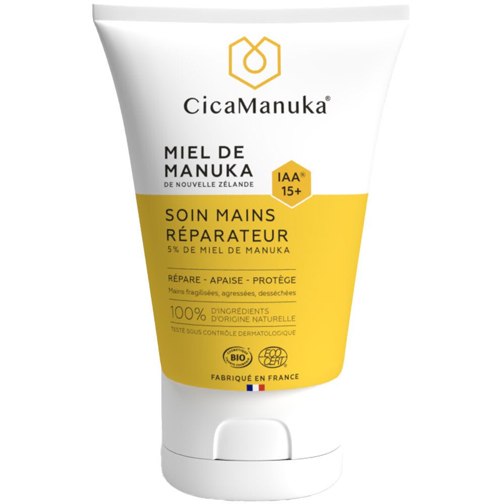 Tube blanc avec étiquette jaune. Inscription: CicaManuka, Miel de Manuka, Soin mains réparateur. Certification IAA15+.