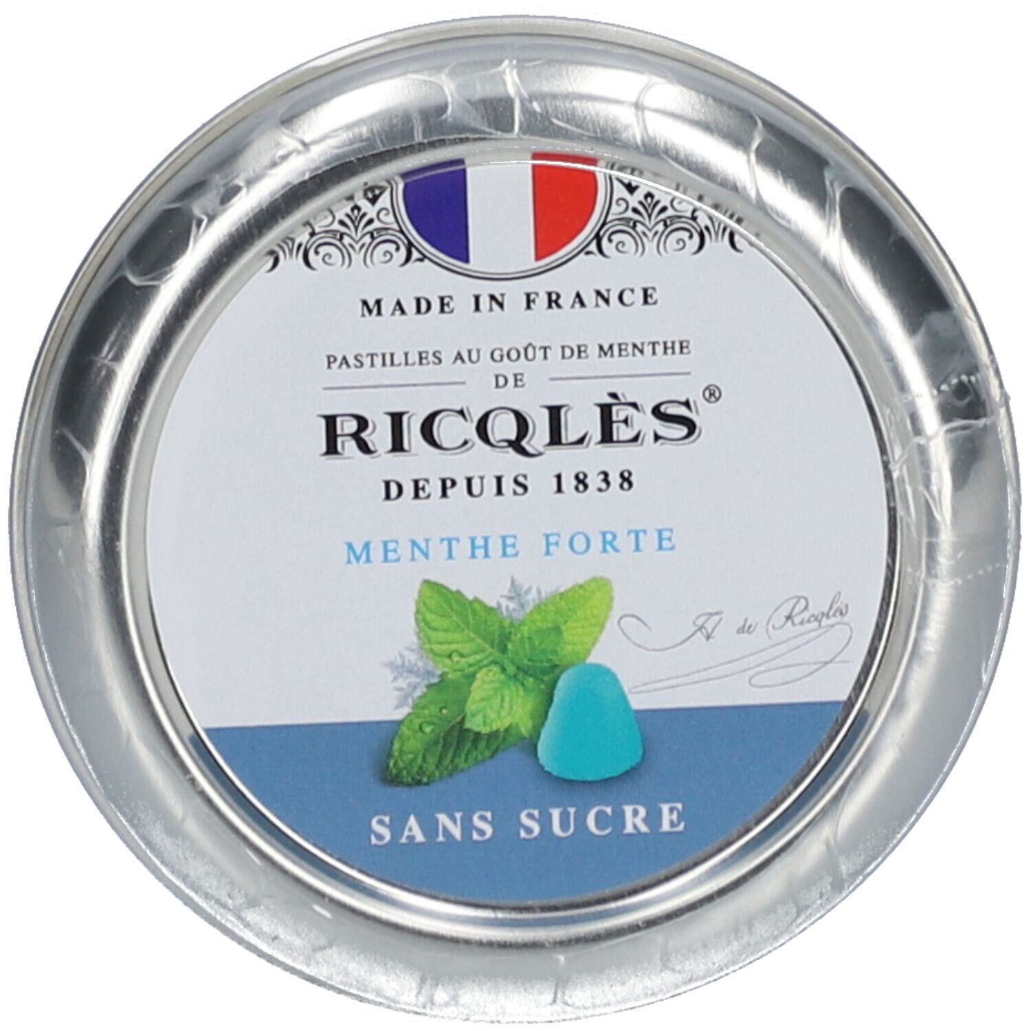 Boîte ronde de pastilles Ricqlès. Drapeau français et texte 'Made in France'. 'Menthe Forte' et illustration de feuilles de menthe.