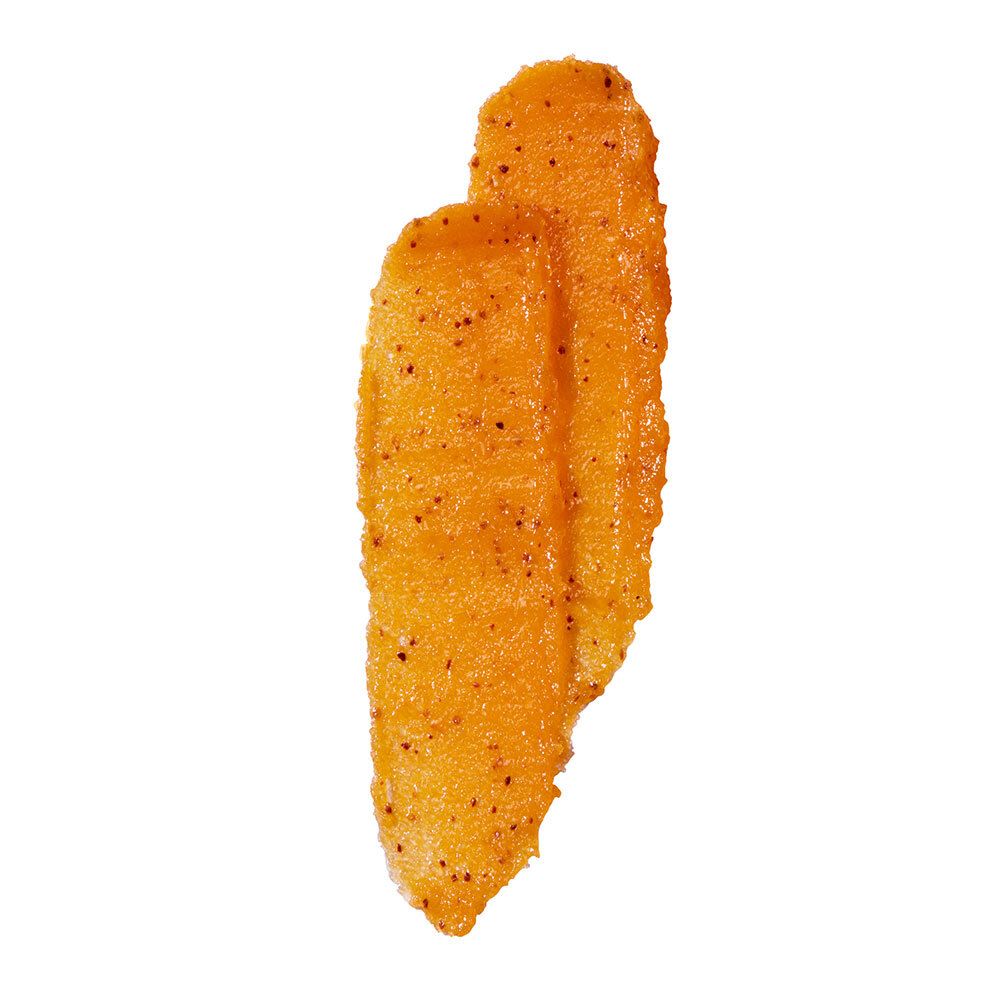 Masque exfoliant orange. Texture avec de petites particules noires. Sur fond blanc.