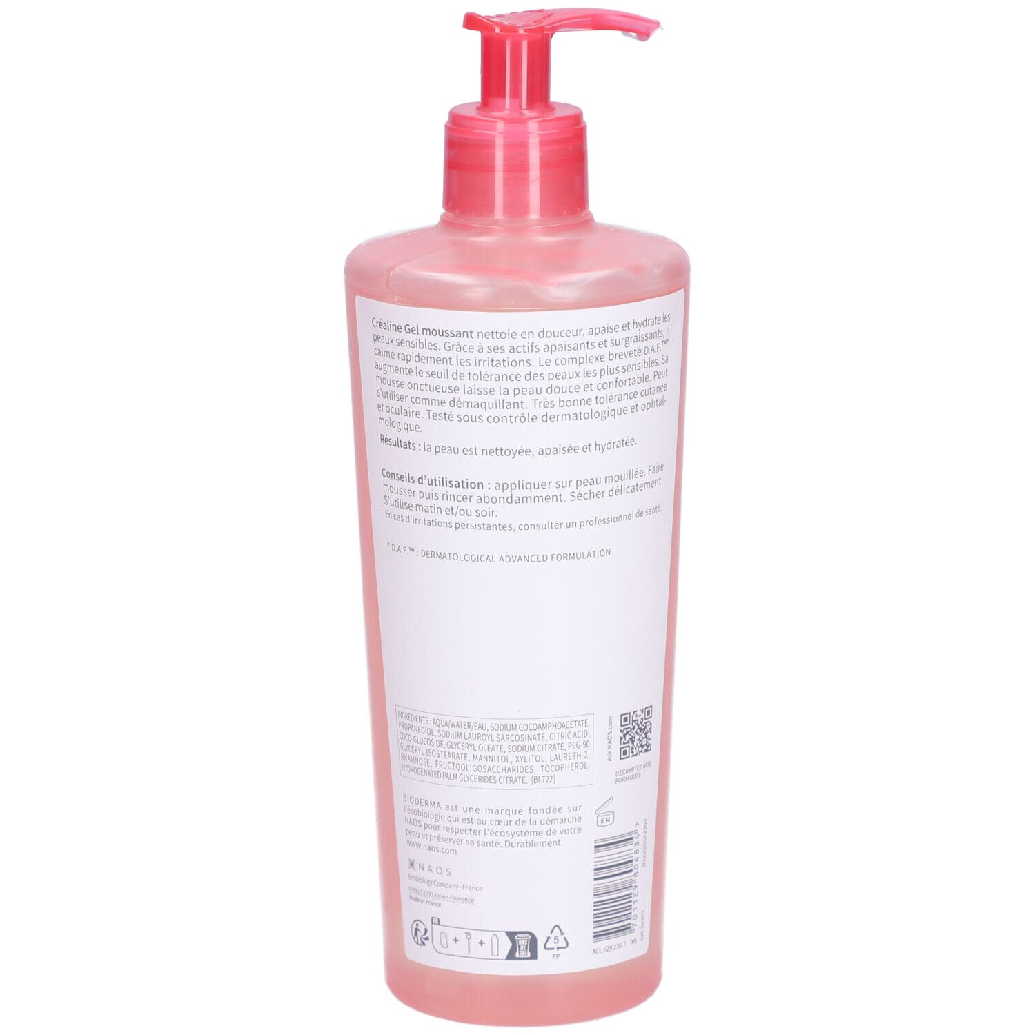 Dos du flacon rose avec pompe. Texte sur étiquette blanche. Informations produit, ingrédients et utilisation.