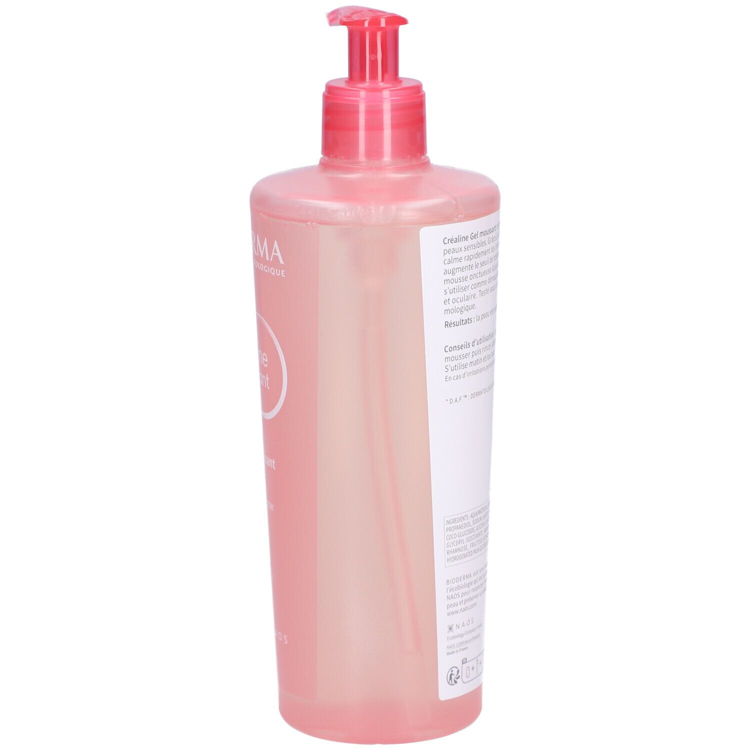 Dos du flacon rose avec pompe. Texte sur étiquette blanche. Informations produit et ingrédients.