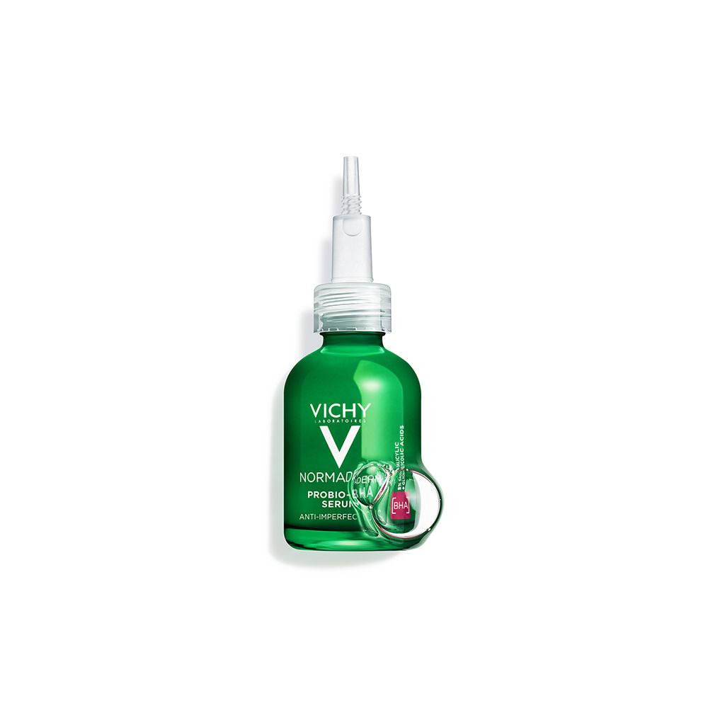 Flacon vert de sérum Normaderm Vichy avec applicateur. Fond blanc.