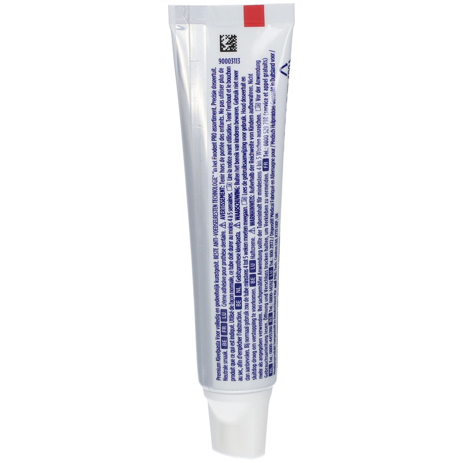 Dos d'un tube de crème adhésive pour prothèses dentaires. Contient du texte, un code-barres et une bande rouge. Nom du produit non visible.