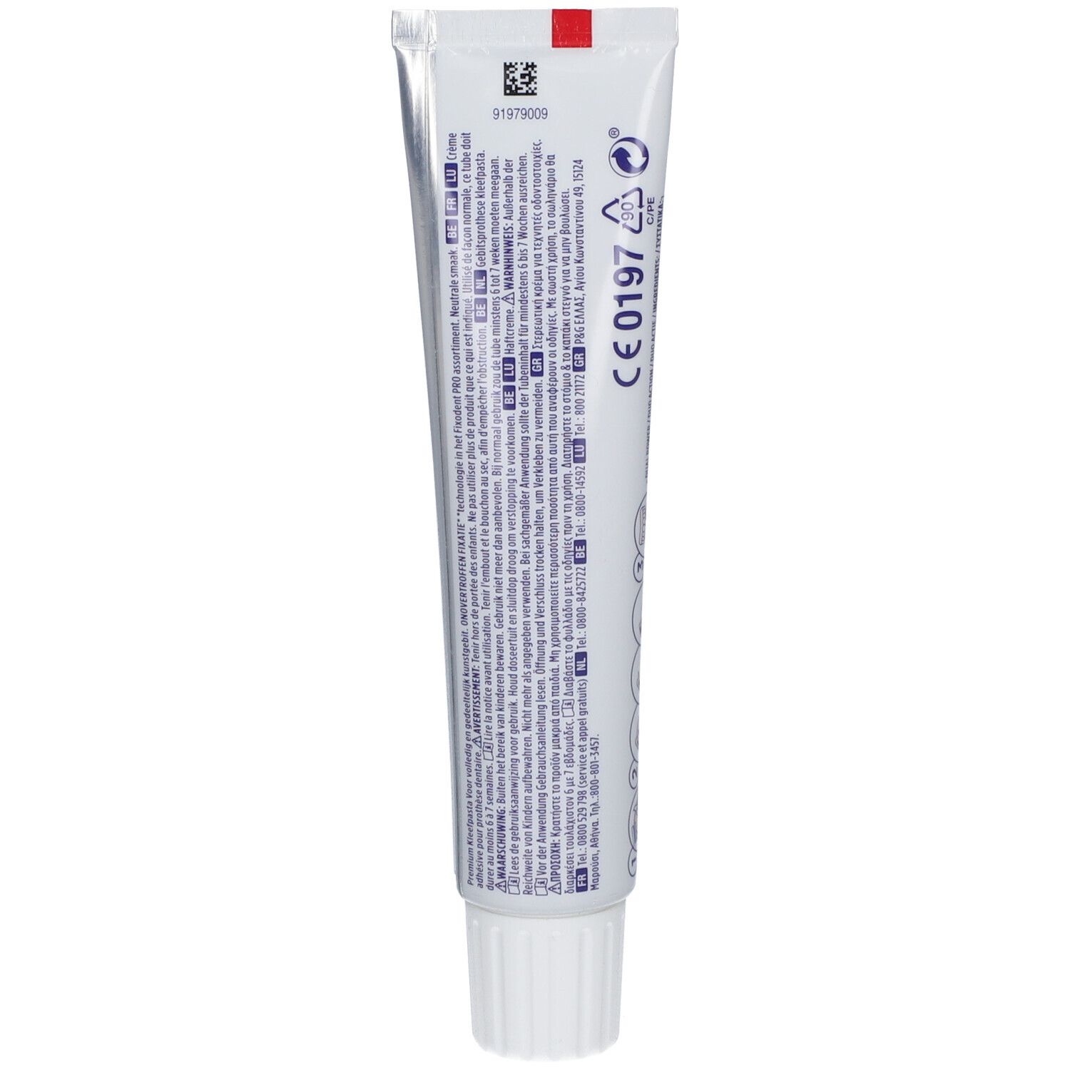 Dos d'un tube de crème adhésive. Texte multilingue. Bande rouge en haut. Bouchon à vis blanc en bas.