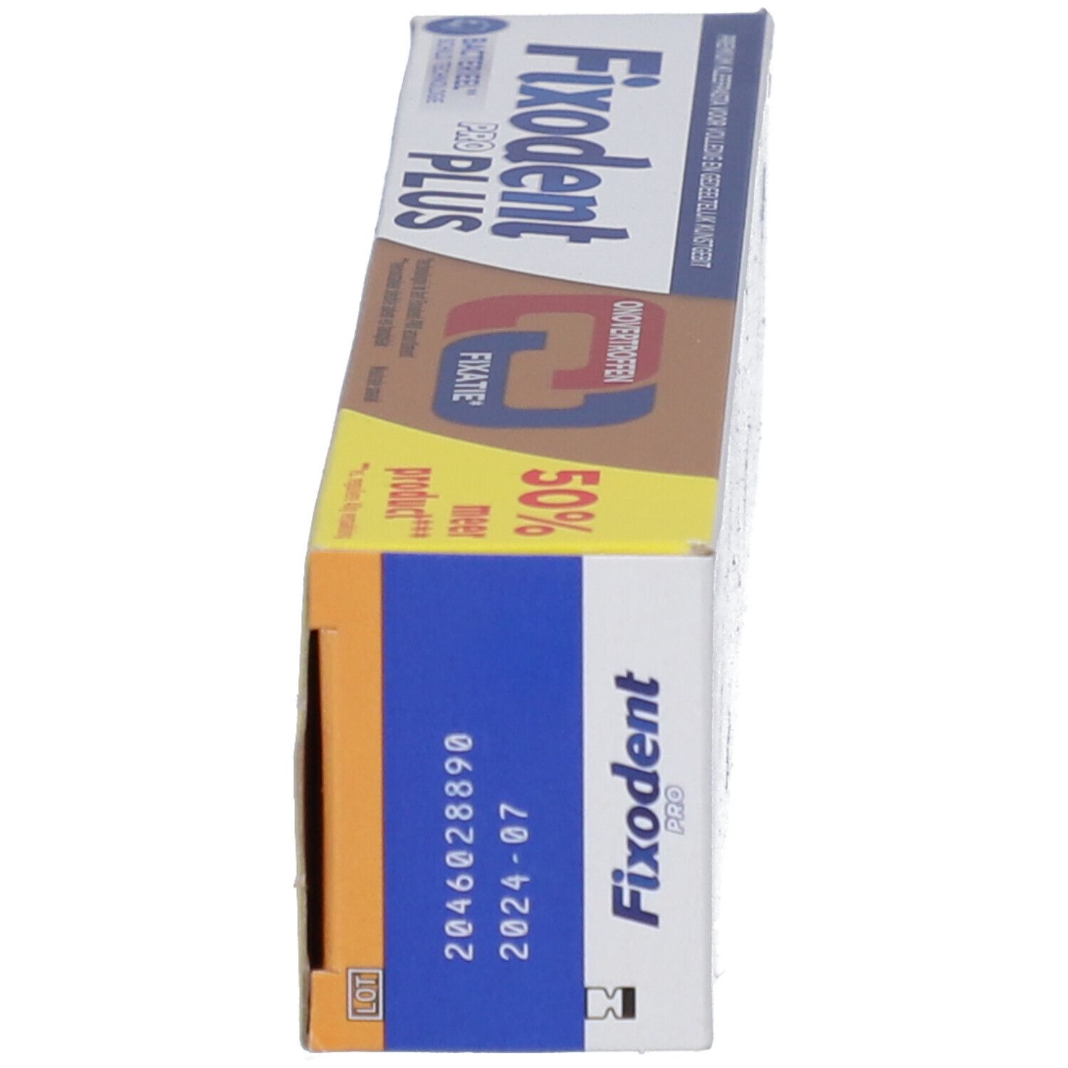 Emballage du produit. Marron, blanc, bleu. Inscription : Fixodent Pro Plus. Avec numéro de lot et date de péremption.