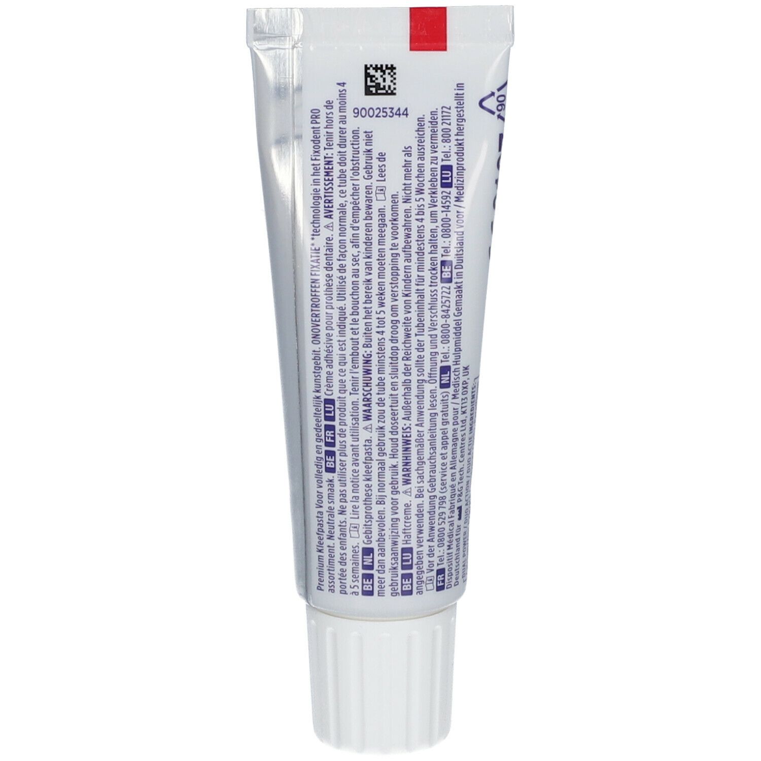 Dos d'un tube de crème adhésive pour prothèses dentaires. Blanc avec texte et bande rouge. Contient informations et avertissements.