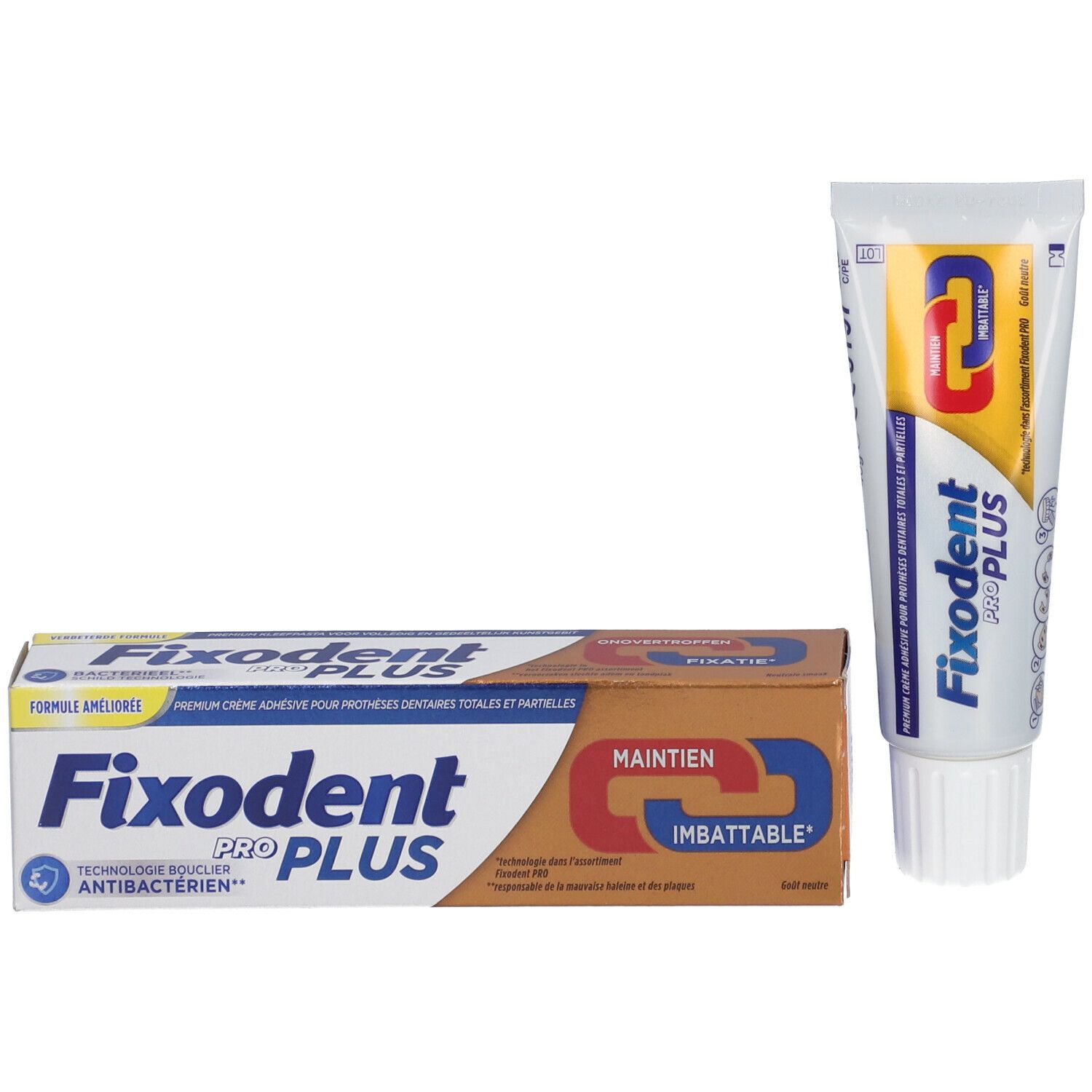 Crème adhésive pour prothèses dentaires et emballage. Tube et boîte. Inscription: Fixodent Pro Plus. Emballage marron et blanc.