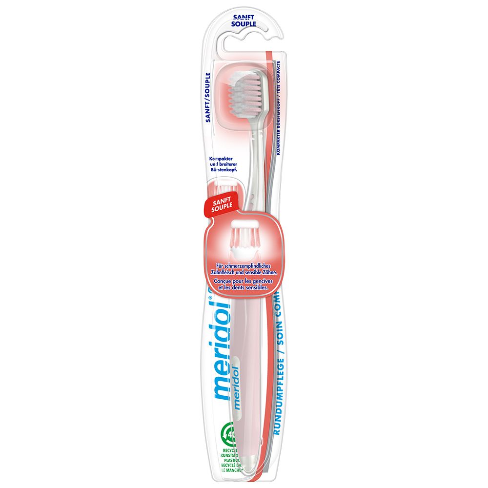 Brosse à dents sous blister. Manche rose, tête blanche. Marque: meridol. Texte: SANFT/SOUPLE.