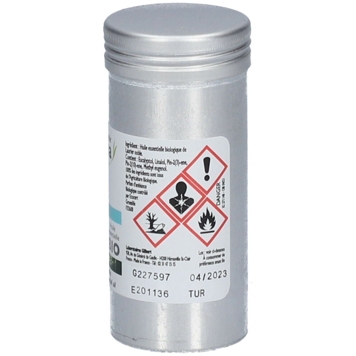 Flacon cylindrique en métal. Étiquette avec symboles de danger, ingrédients et date de péremption 04/2023.