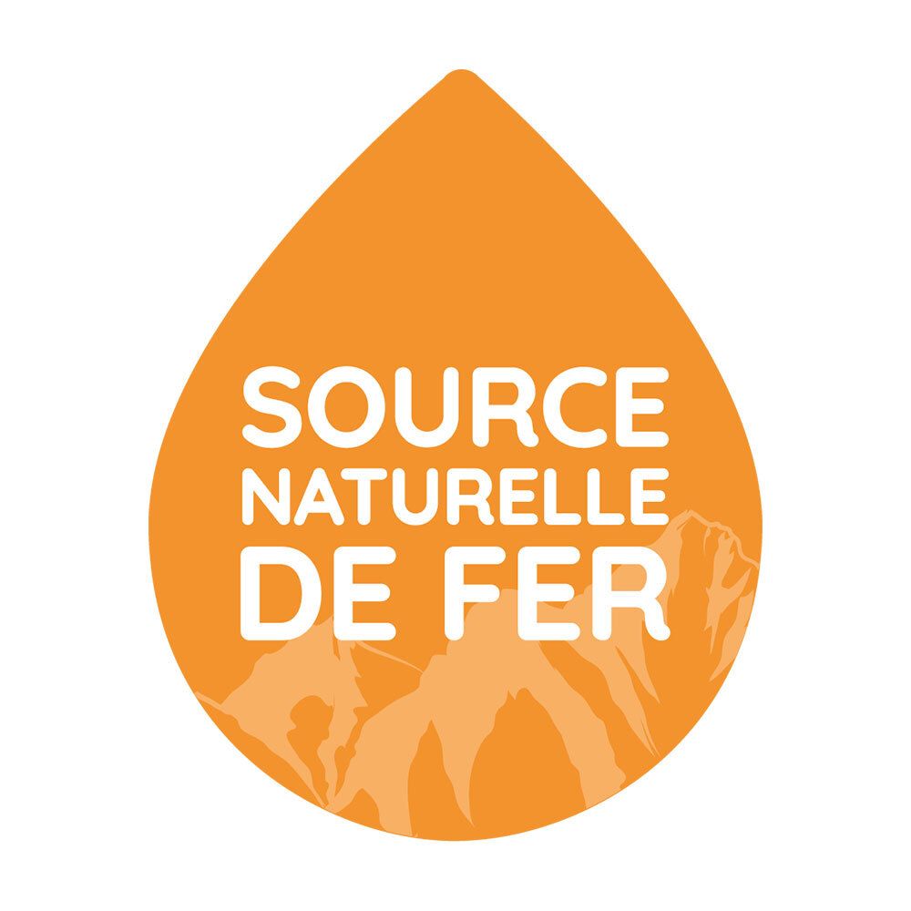 Goutte orange avec texte : Source naturelle de fer. Montagnes en arrière-plan.