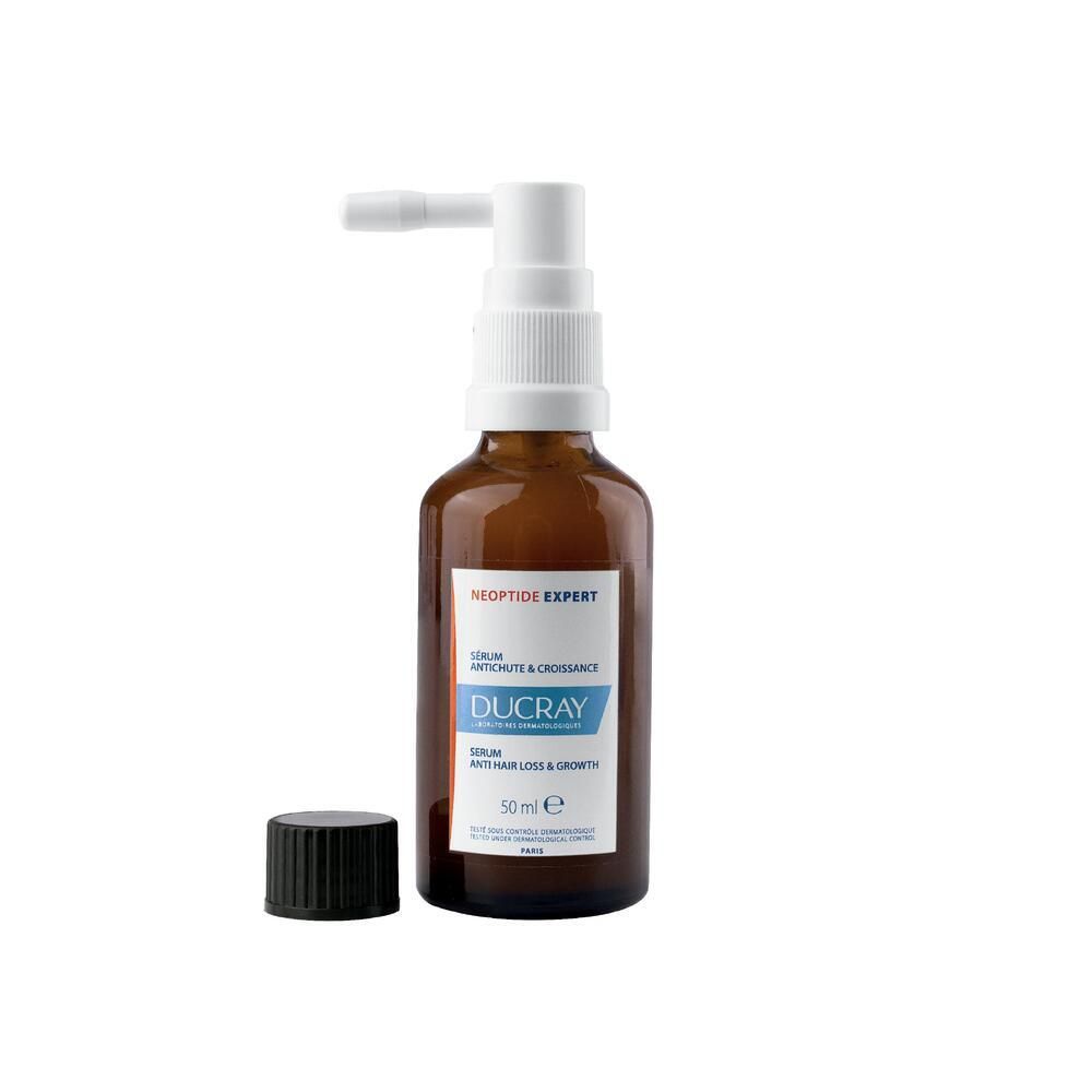 Bruine fles met verstuiver. Etiket met productinfo. Zwarte dop ernaast.