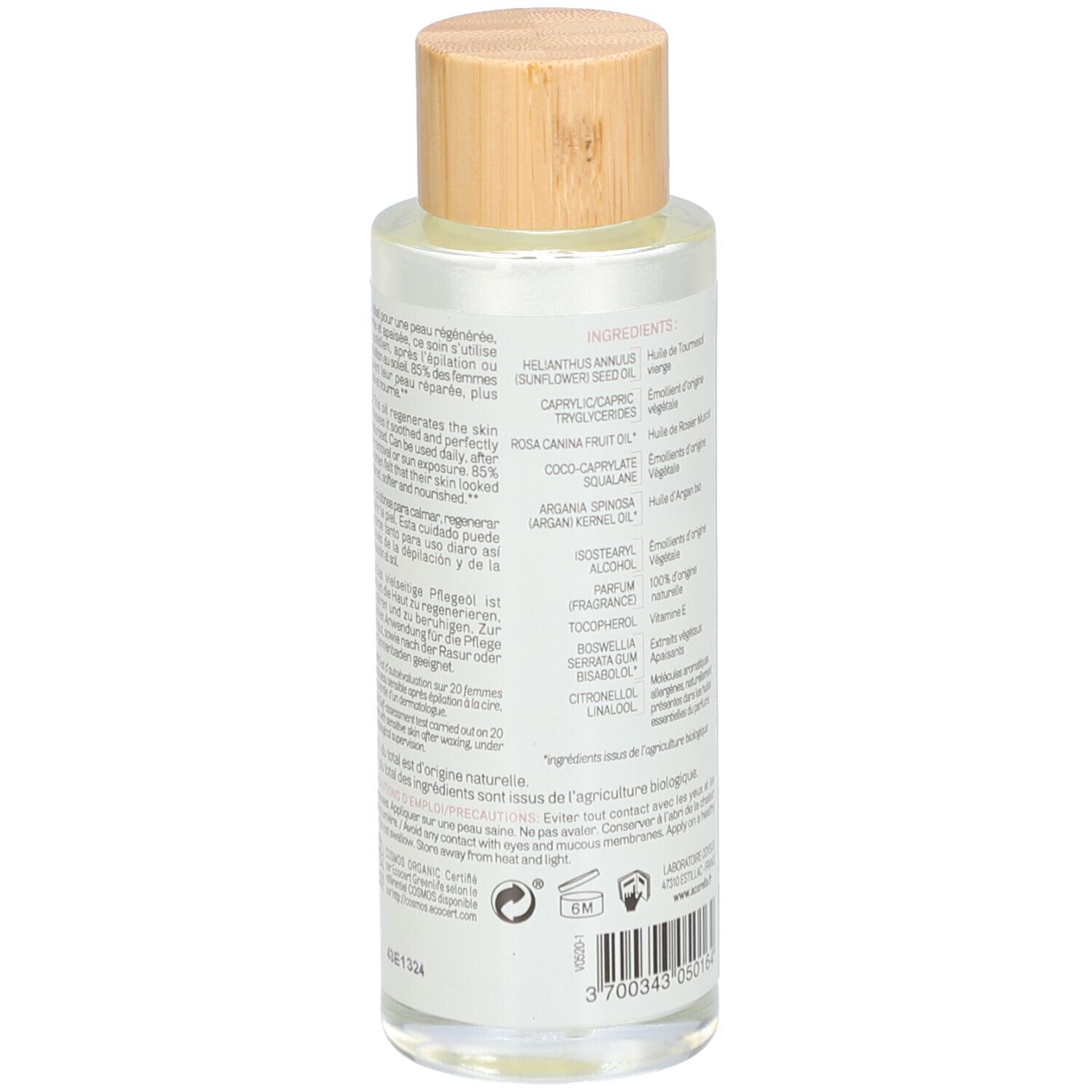 Dos du flacon en verre avec informations sur les ingrédients. Bouchon en bois. Étiquette avec ingrédients et logos. Texte multilingue.