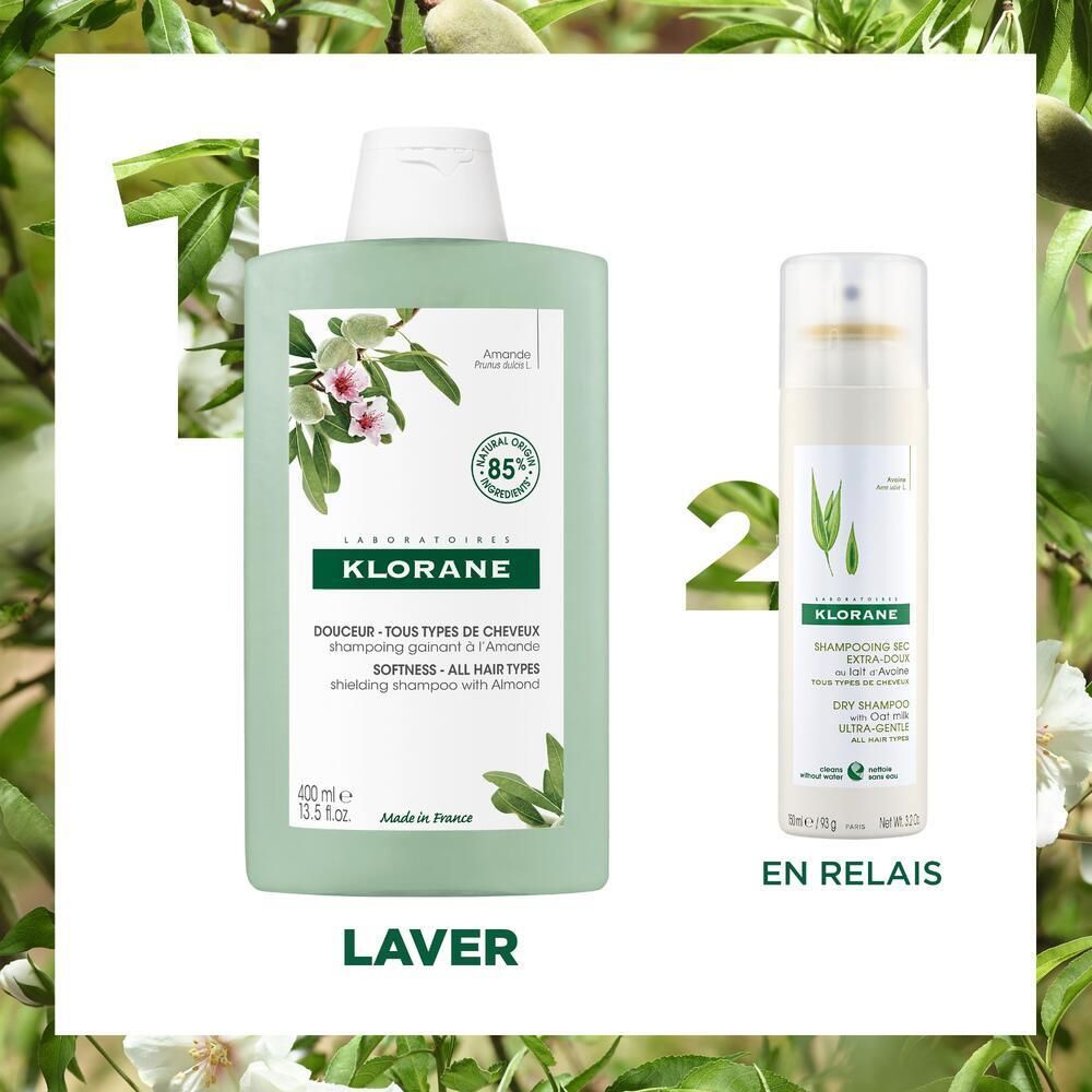 Deux produits: flacon de shampooing et spray de shampooing sec. Flacon: vert clair, bouchon blanc, KLORANE. Spray: blanc, KLORANE. Fond: feuilles et fleurs.