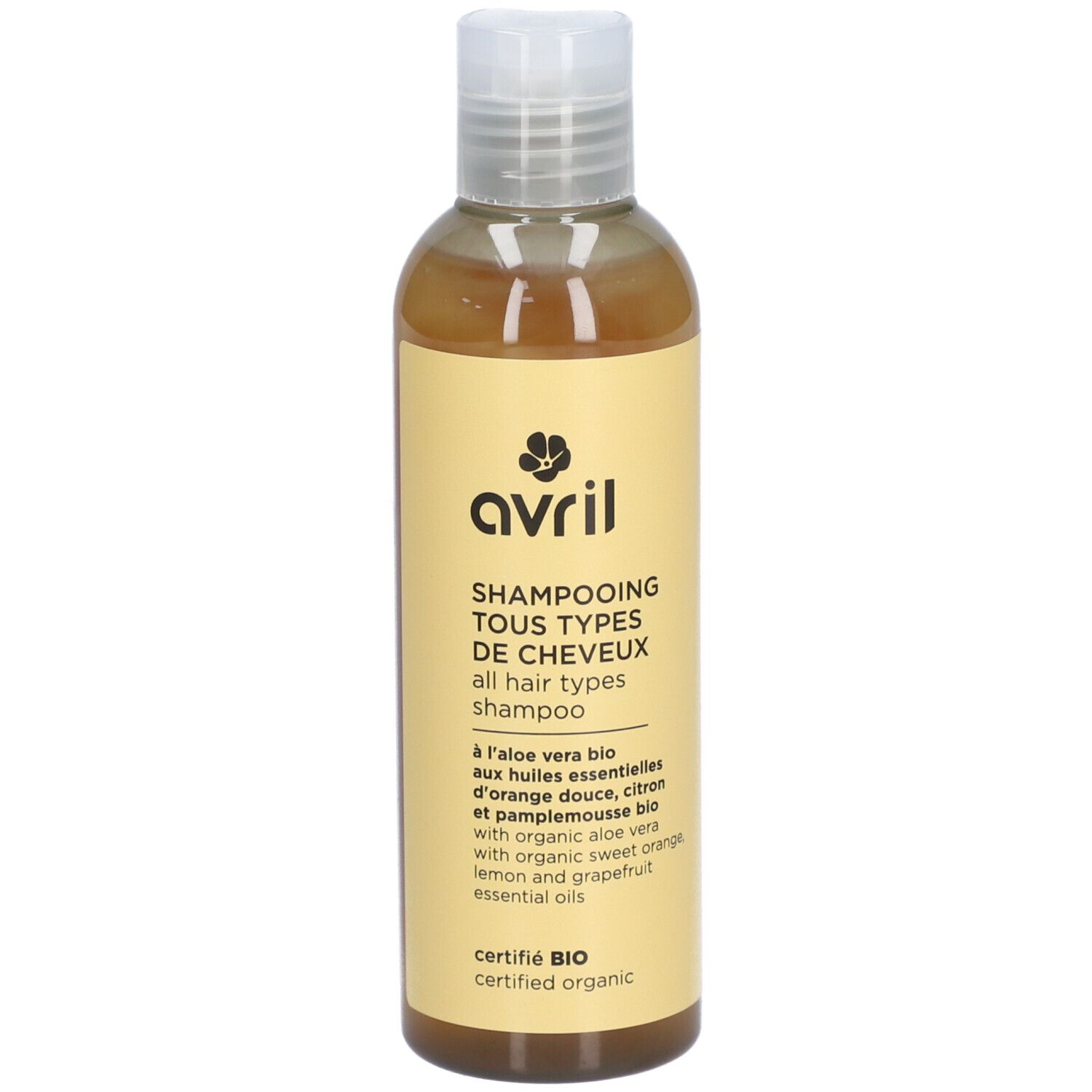Flacon de shampooing avec étiquette jaune. Texte: Avril, Shampooing Tous Types de Cheveux, certifié Bio.