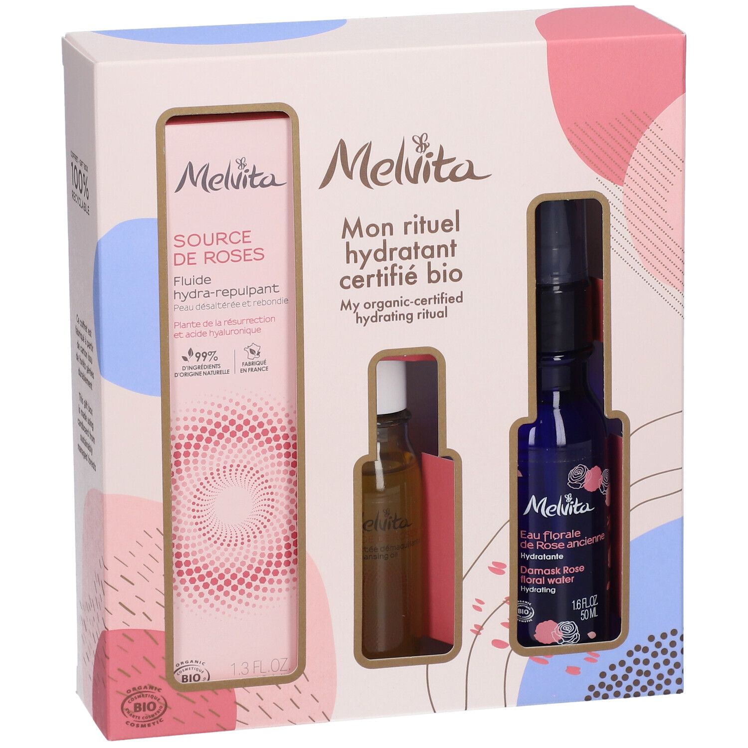 Geschenkbox mit drei Produkten. Links: Flasche mit Flüssigkeit. Mitte: kleine Flasche. Rechts: blaue Flasche mit Sprühkopf.