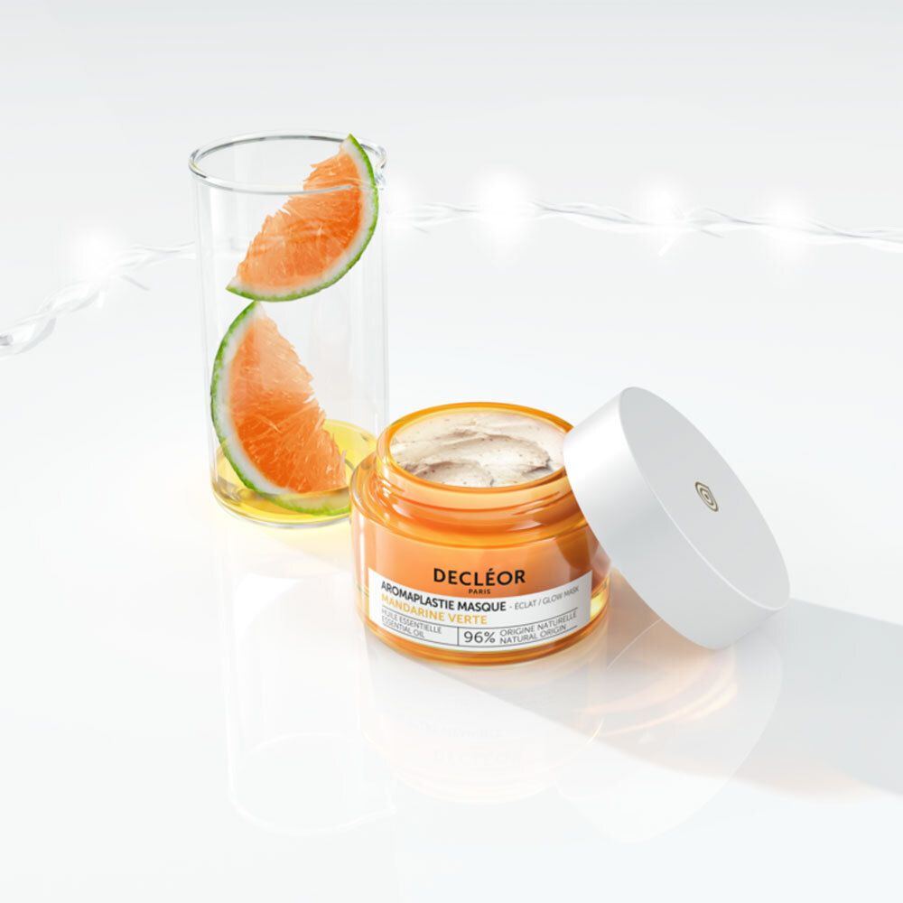 Pot de masque facial, couvercle ouvert. Pot orange, couvercle blanc. Inscription : DECLÉOR, Aromaplastie Masque, 96% origine naturelle.
