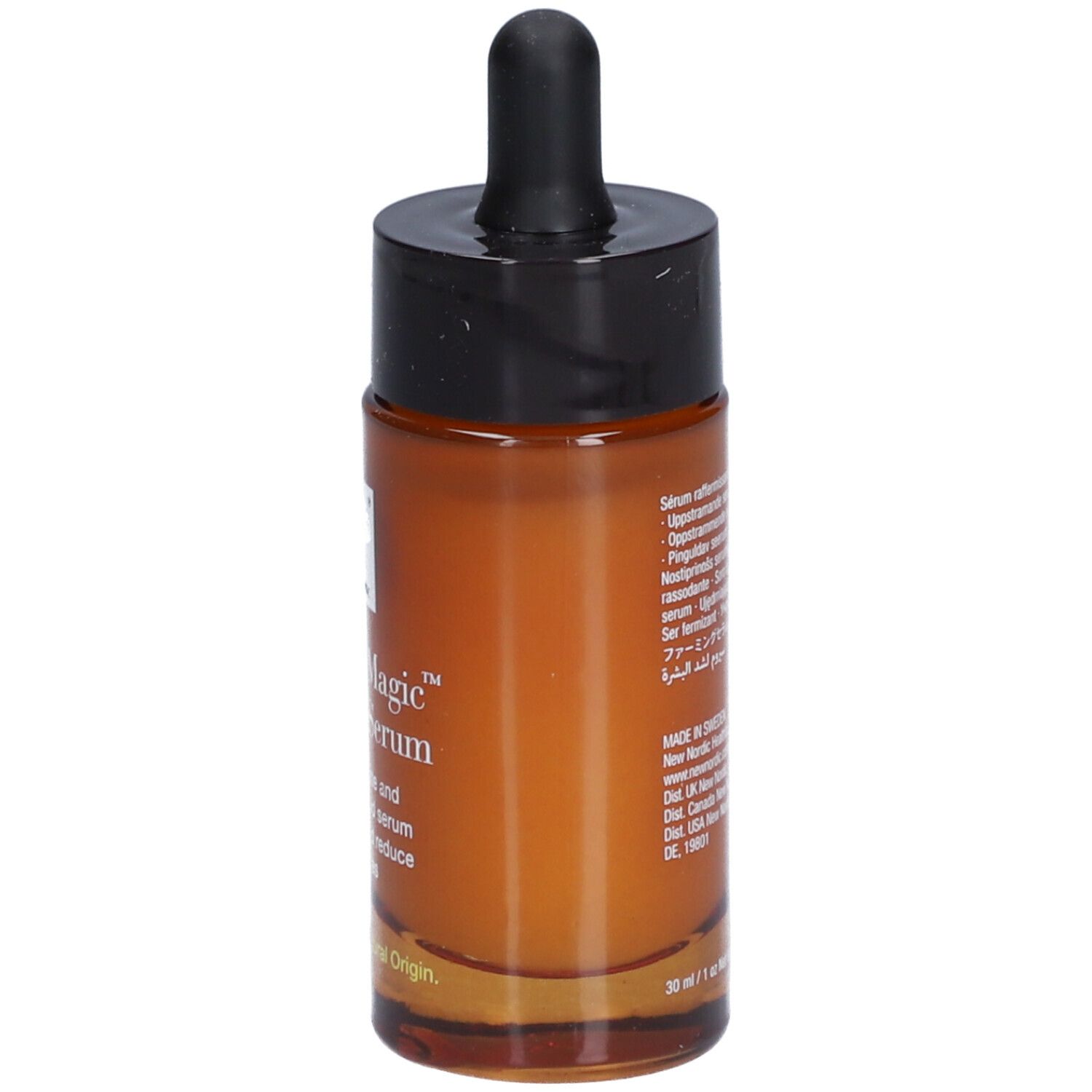 Flacon en verre brun avec bouchon noir et pipette. Inscription : Natural Magic Firming Serum.