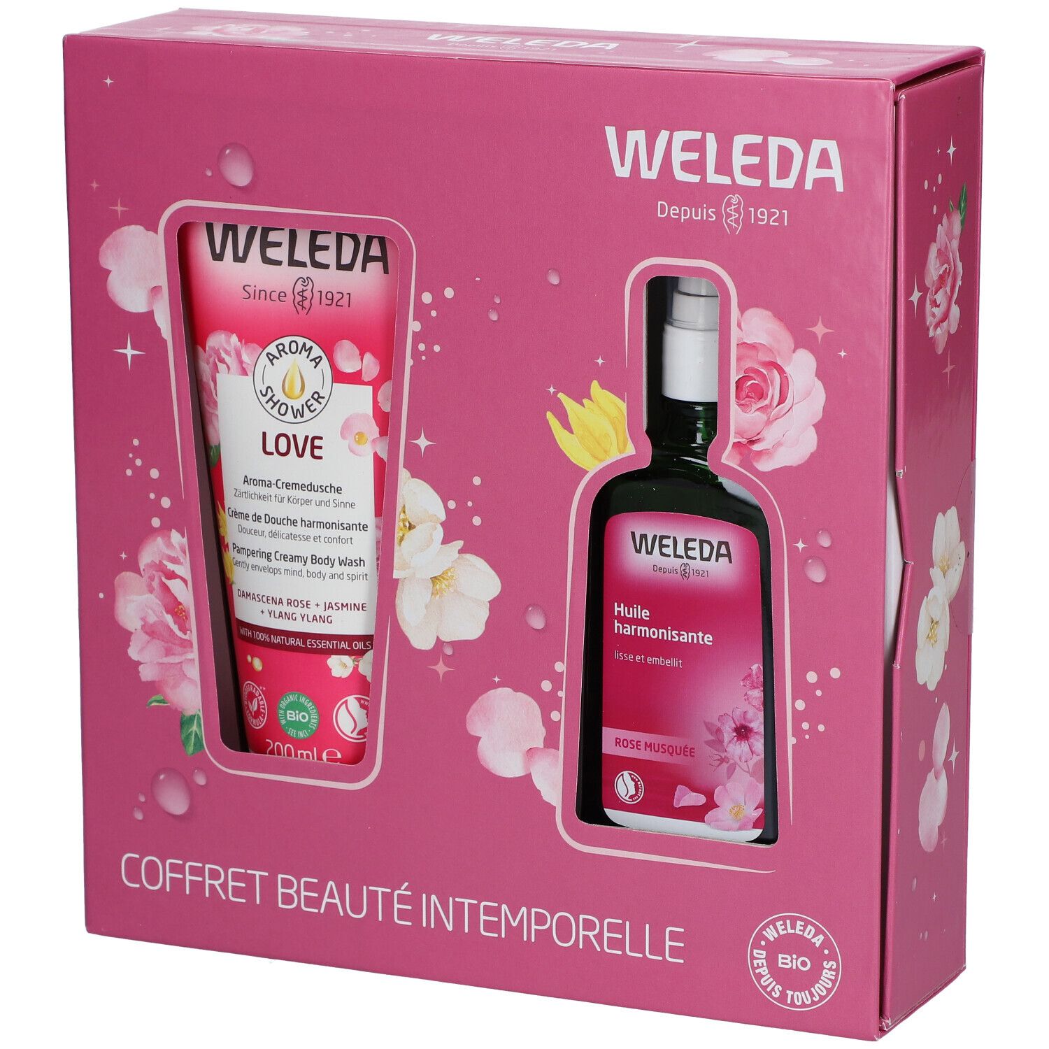Coffret rose avec deux produits: gel douche et huile. Inscriptions: WELEDA, COFFRET BEAUTÉ INTEMPORELLE.