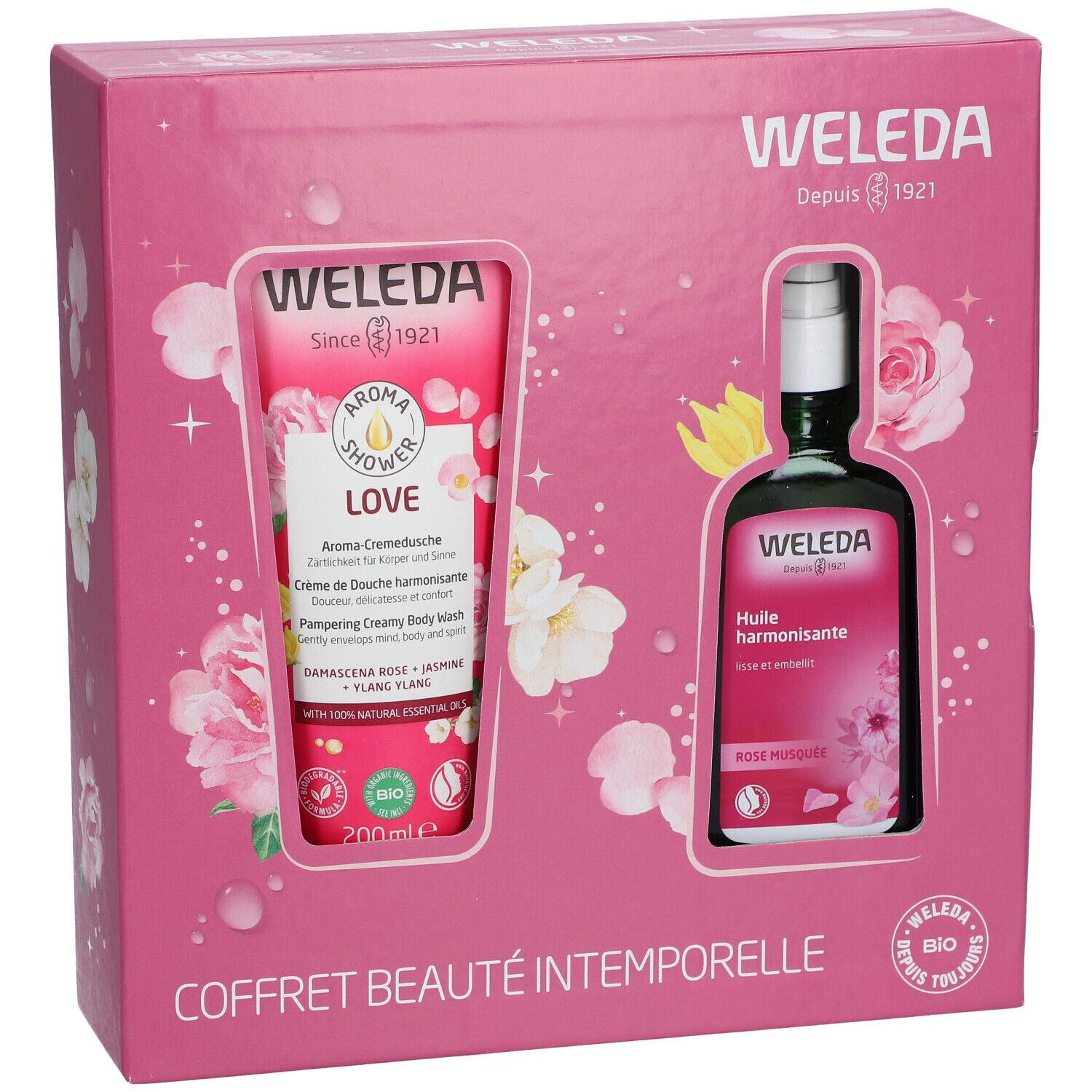 Coffret rose avec deux produits: gel douche et huile. Inscriptions: WELEDA, COFFRET BEAUTÉ INTEMPORELLE.