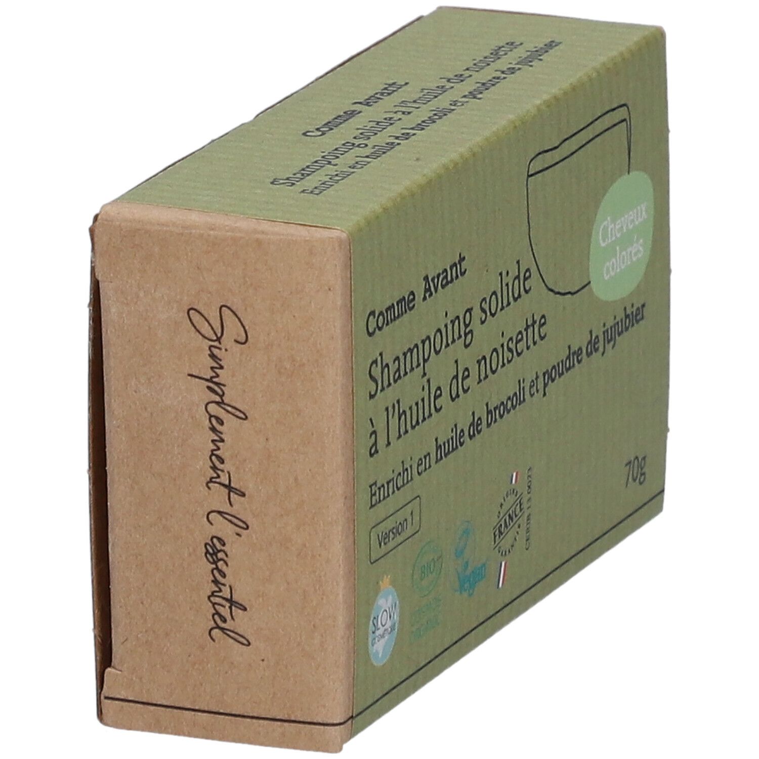 Boîte en carton, vue en biais. Impression: Comme Avant, Shampoing solide à l'huile de noisette. Labels Vegan et Bio.