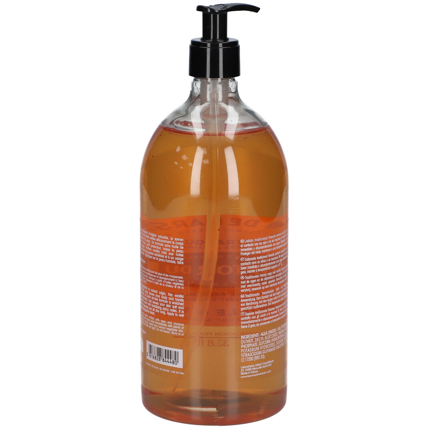 Vue arrière d'un flacon transparent avec liquide brun. Pompe noire. Étiquette avec texte et ingrédients.