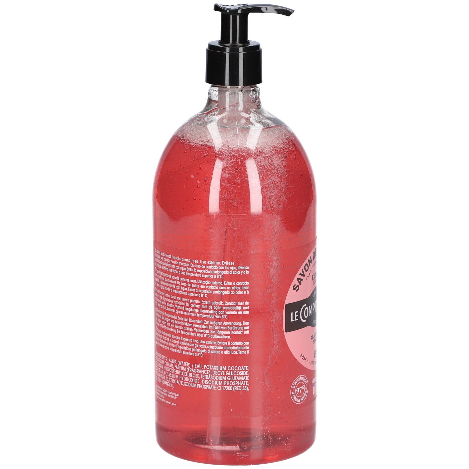 Dos du flacon transparent de savon liquide rose. Pompe noire. Texte sur l'étiquette.