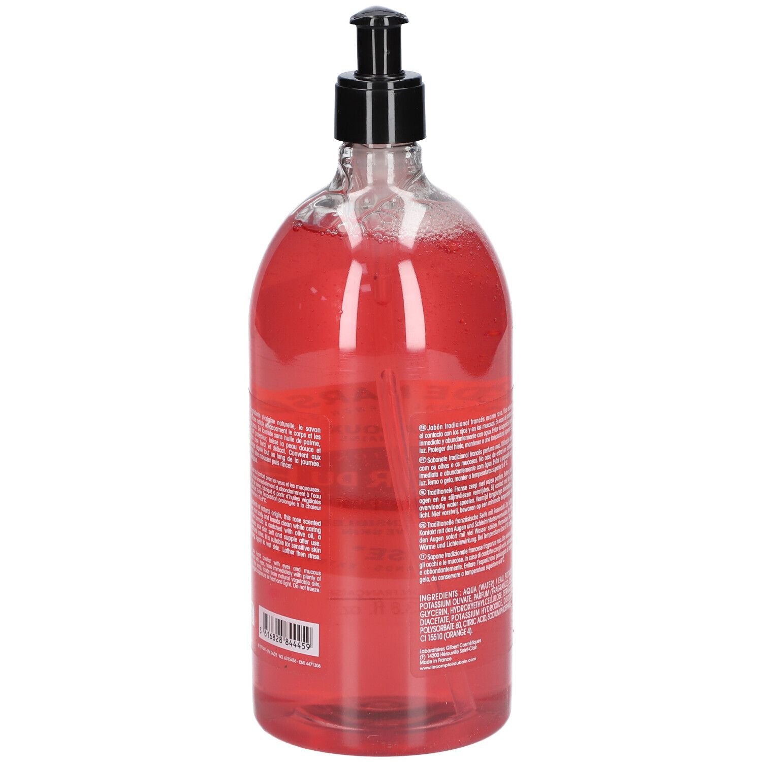 Vue arrière du flacon transparent de savon liquide rose. Pompe noire. Texte sur l'étiquette.