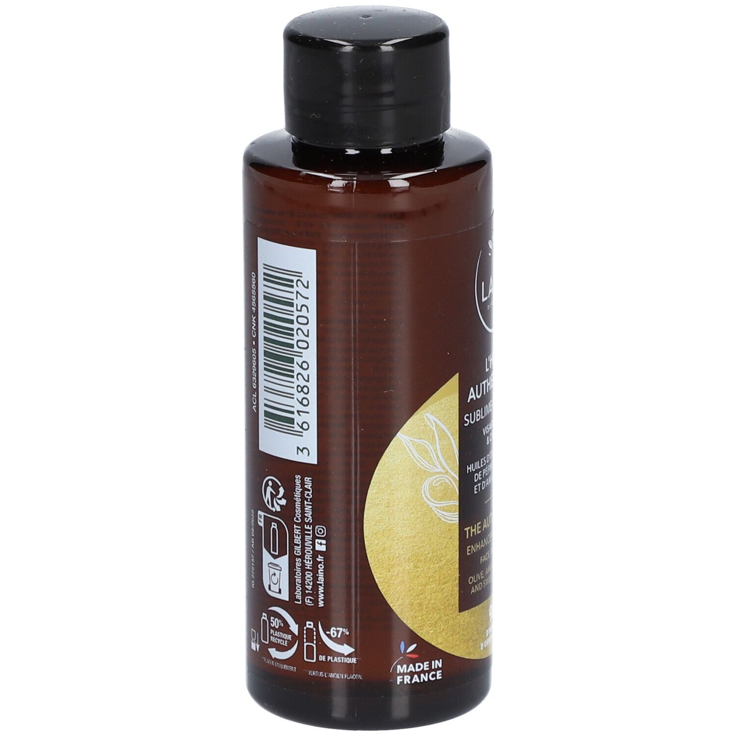 Achterkant van een bruine fles met zwarte dop. Opschrift: LAINO, L'HUILE AUTHENTIQUE. Informatie over ingrediënten en fabrikant.