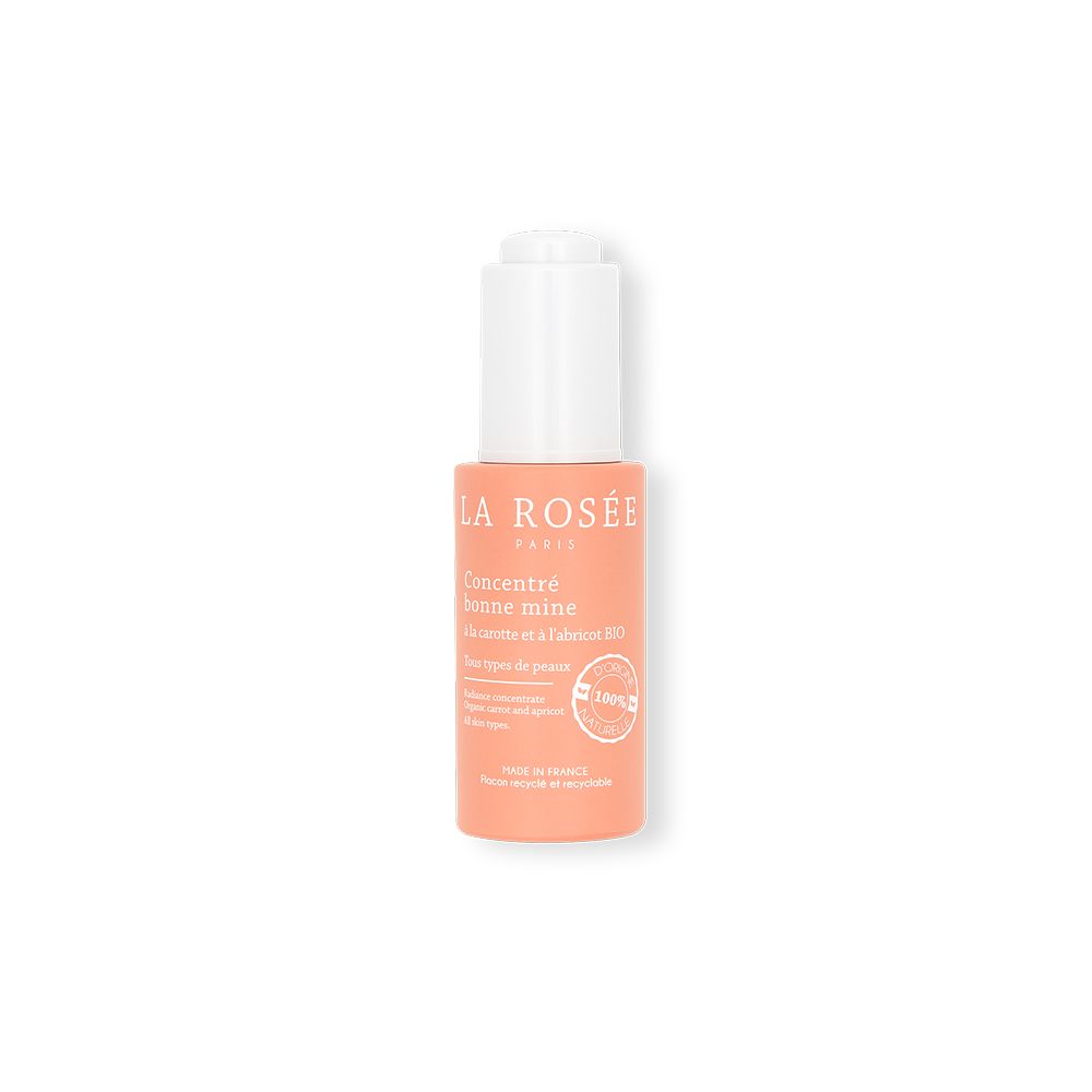 Roze fles met witte dop. Opschrift: LA ROSÉE, Concentré bonne mine. Met wortel en abrikoos. 100% natuurlijk.